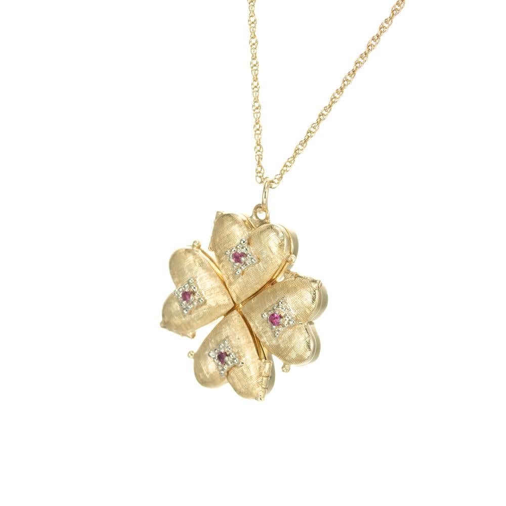 Vintage 1960's ruby heart pendant necklace. Four, 14k yellow gold 4 heart lockets that open and can hold pictures. Each heart has one round ruby.  Hand Florentine finish. 17 Inch rope chain.

4 round red rubies, approx. .6cts
14k yellow gold