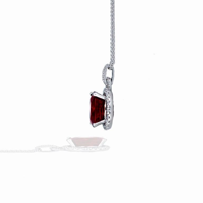 This stunning spessartite garnet and diamond pendant consists of the following.   The center stone is a natural orange red spessartite garnet that measures  11.12mm X 8.99mm Depth 6.21mm.  Its held in a four pring head and has  36 - 1-1.5mm Round