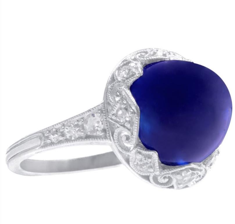 6ct Sugar Loaf Cut Cabochon Sapphire Ring. Art deco period platinum filigree ring set with a 6.08ct sugar loaf cut cabochon sapphire and side diamonds weighing 0.30cts. Center Kashmir Sapphire comes with AGTA certification guaranteeing natural