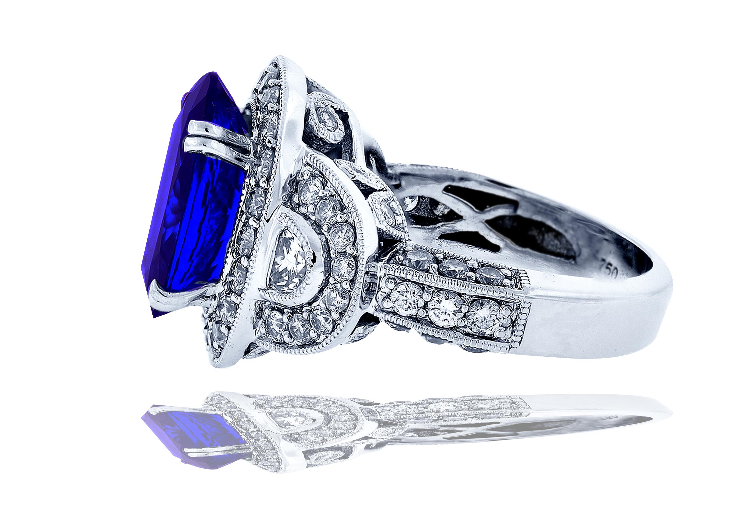 A stunning demonstration of classic jewelry, this ring has a stunning deep purple blue Tanzanite centered.  The center stone is 6 carats apprx. and shows perfection in its color and clarity being a AAAA color and VS clarity.  The center stone is