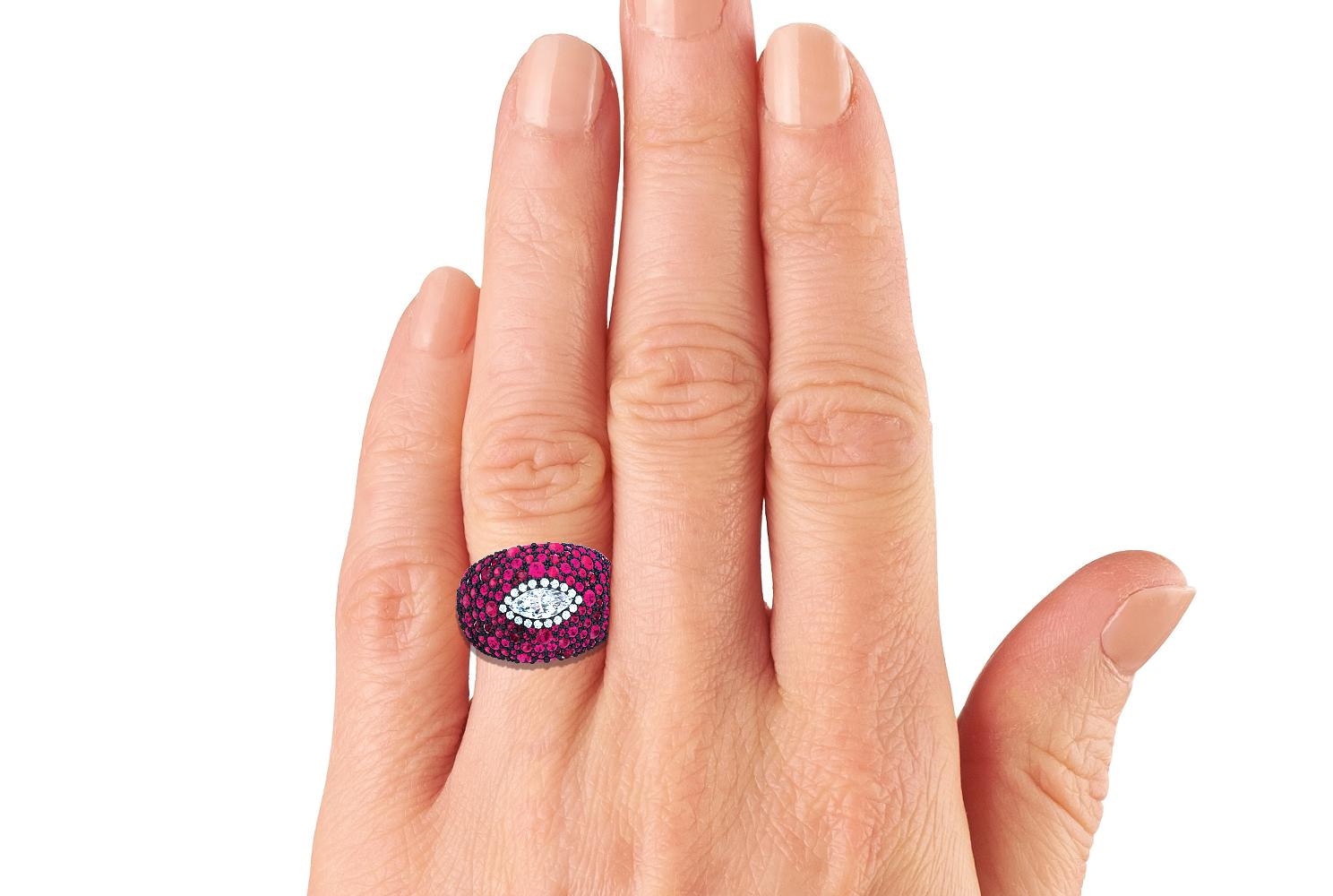 This beautiful and bold yet sophisticated ruby and tourmaline ring gives the wearer a beautiful array of reds and pinks set in a blackened silver that really allows the rubies to be bold and stand out.  The center diamonds is a .90 carat old