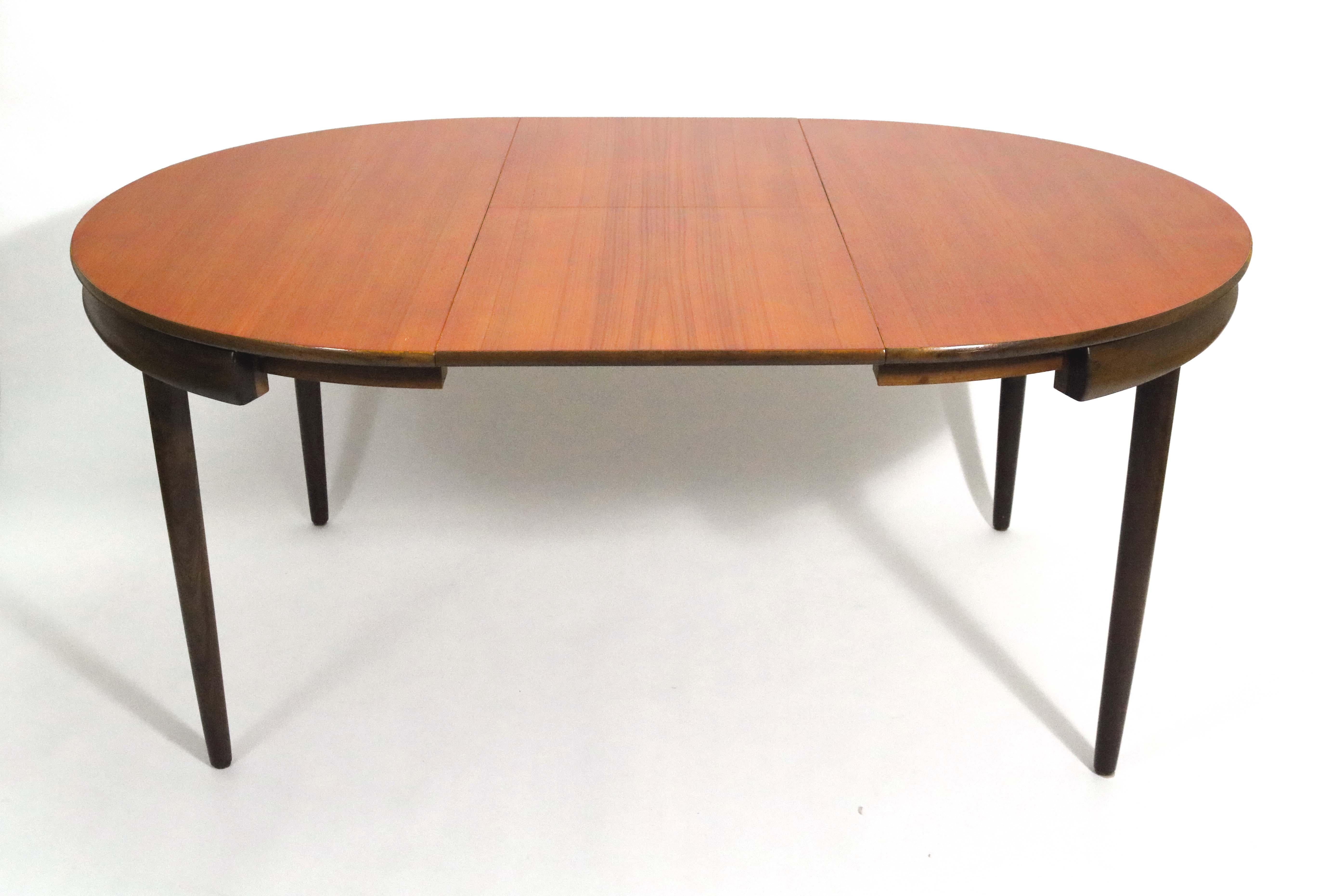 Hans Olsen’s iconic teak dining table with 6 chairs by Hans Olsen for Frem Røjle. 

The chairs tuck neatly into the outer rim of the table. These are the 4-legged chairs, not the 3-legged versions also creaated by Olsen for these tables. 

The