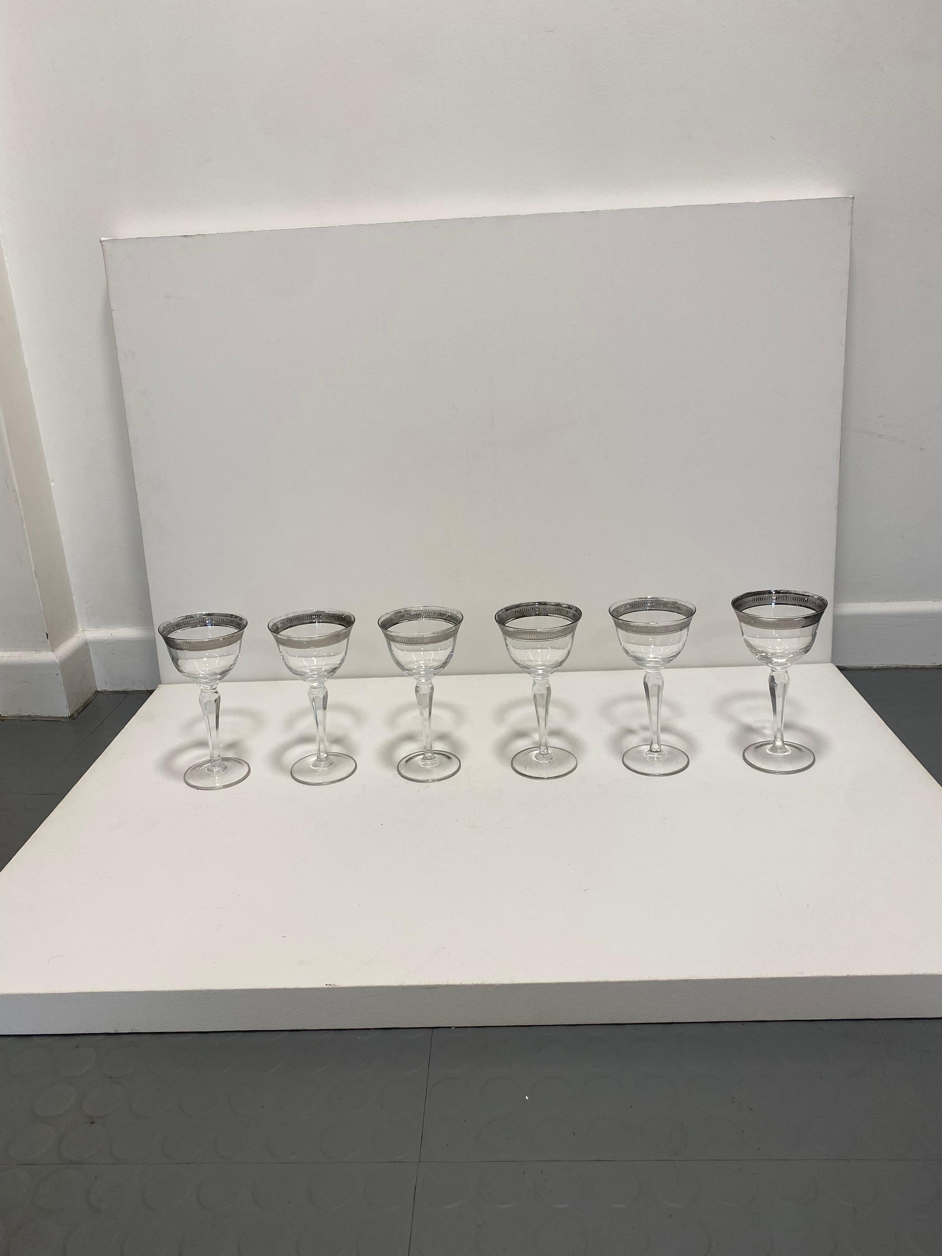 A set of six crystal wine glasses, dating back to the 1930s. Miraculously all set of six glasses survived all these years.

The glasses have a classic timeless design, with diamond column cut and silver trim on the base and on the top with an