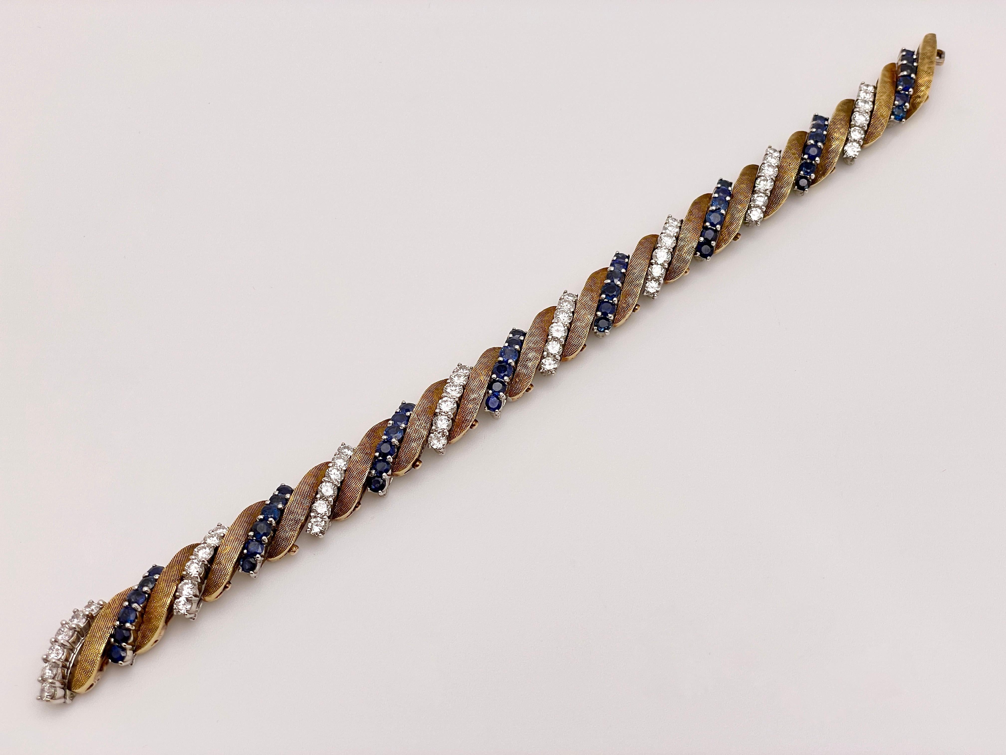 An original antique 14K white and yellow gold diamond and sapphire bracelet. Boasting eight rows of round brilliant cut diamonds totaling to 48, and eight rows of round brilliant cut sapphires also totaling to 48. These rows are separated by