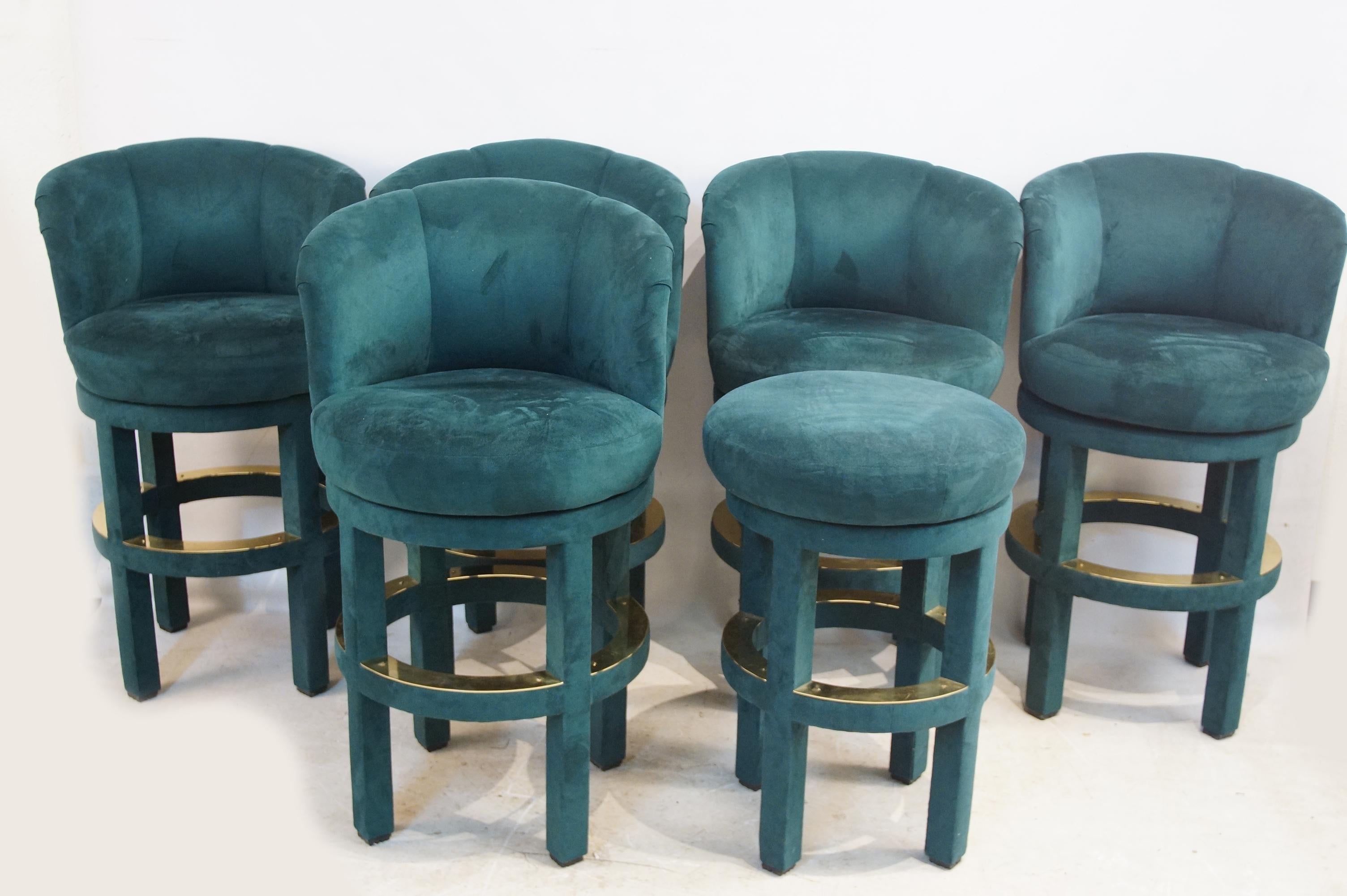 Custom made bar stools in a dark green velour, with brass trim, five with backs, one without. Measurements are estimated.