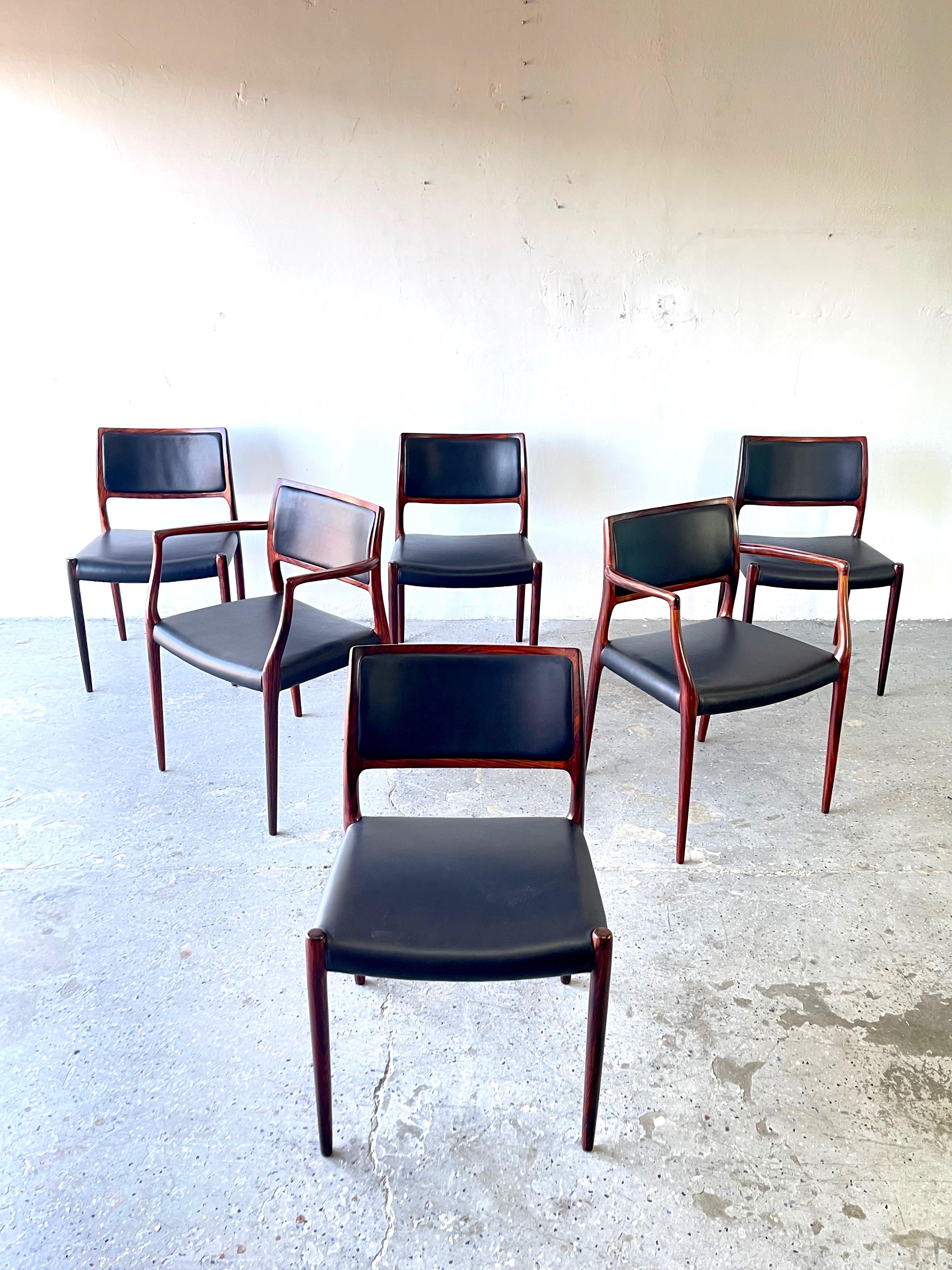 This beautiful set of 6 dining chairs by Niels O. Møller for J.L. Møllers Møbelfabrik consists of four model 80 side chairs and two model 65 armchairs. The frames are sculpted of rich rosewood All are like new and have been professional