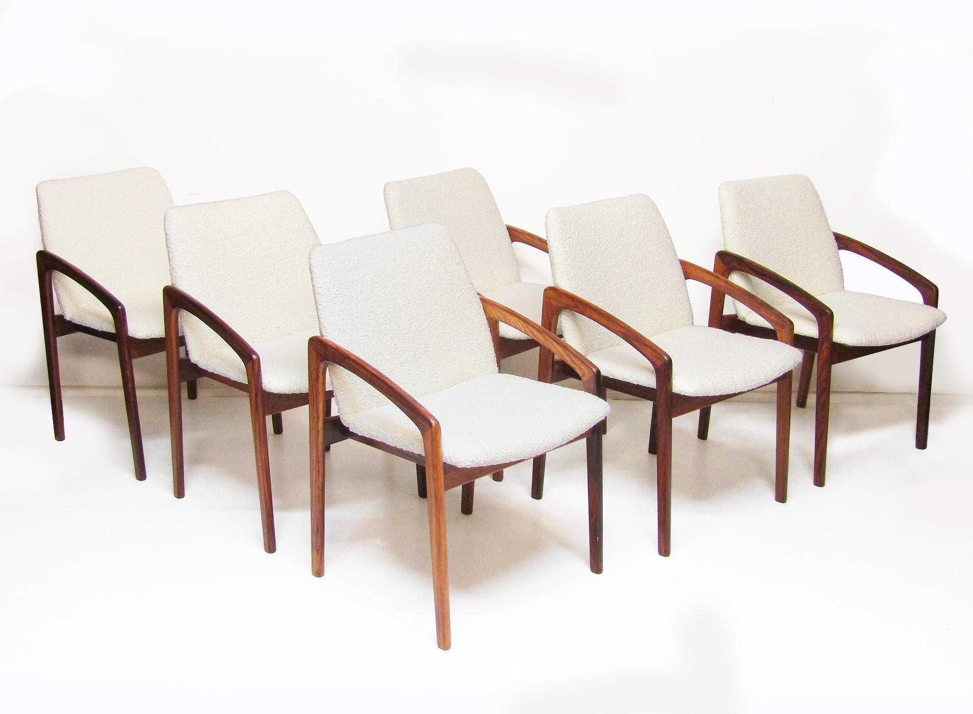 A set of six 1960s Danish rosewood dining chairs by Henning Kjaernulf for Korup Stolefabrik.

They have been reupholstered in a soft, luxurious ivory bouclé fabric.

The rosewood version of this chair is very rare. The beautifully grained wood