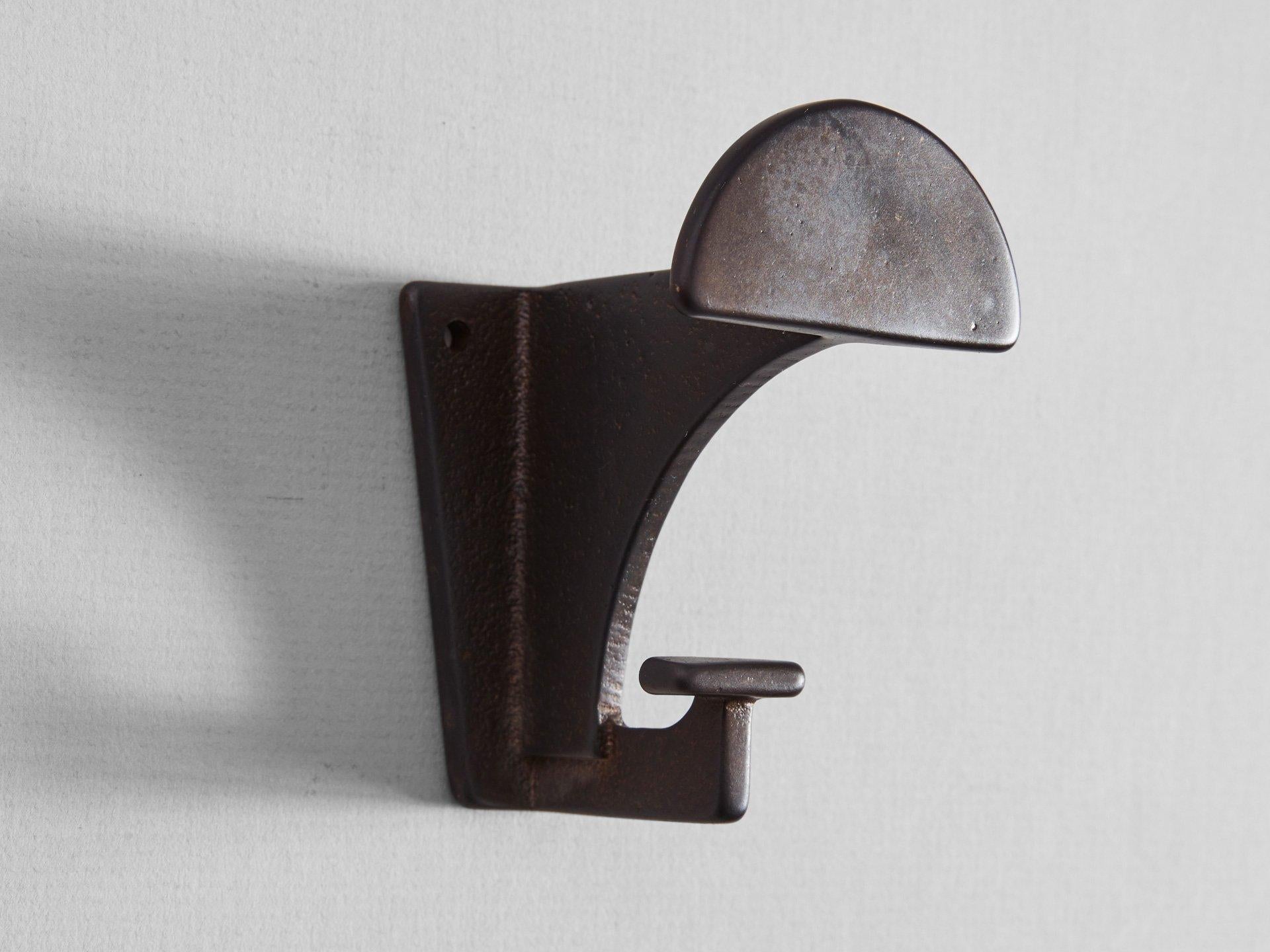 6 dark bronze contemporary Hooks by Henry Wilson
The blackened compass hook is made, finished and polished in Sydney, Australia using sand-casted gunmetal bronze. For its size, it can bear a surprisingly substantial heft.  

Sand-casting involves