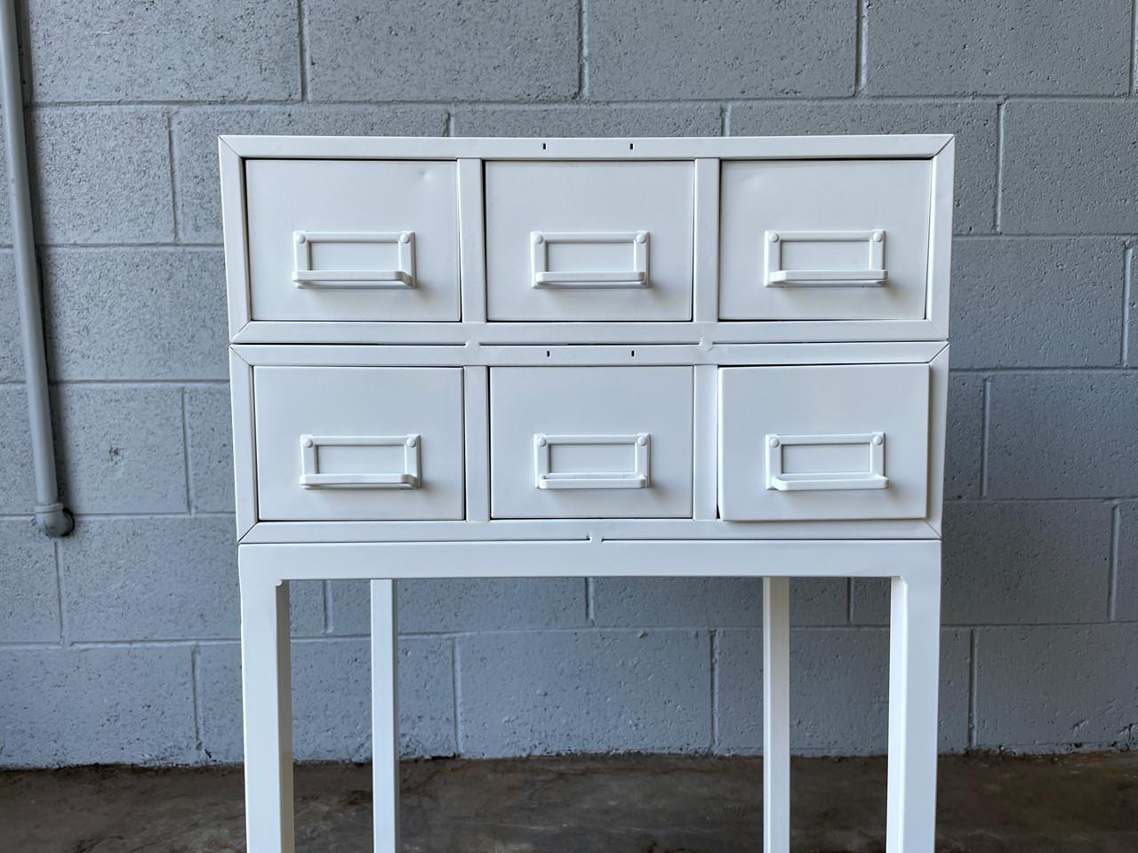 Two vintage 3-drawer card files mounted on custom-made base. Great side table for small-item storage/ office supplies & printer. Gloss white powder coat finish. In excellent vintage condition as pictured.

Dimensions: 18 1/2