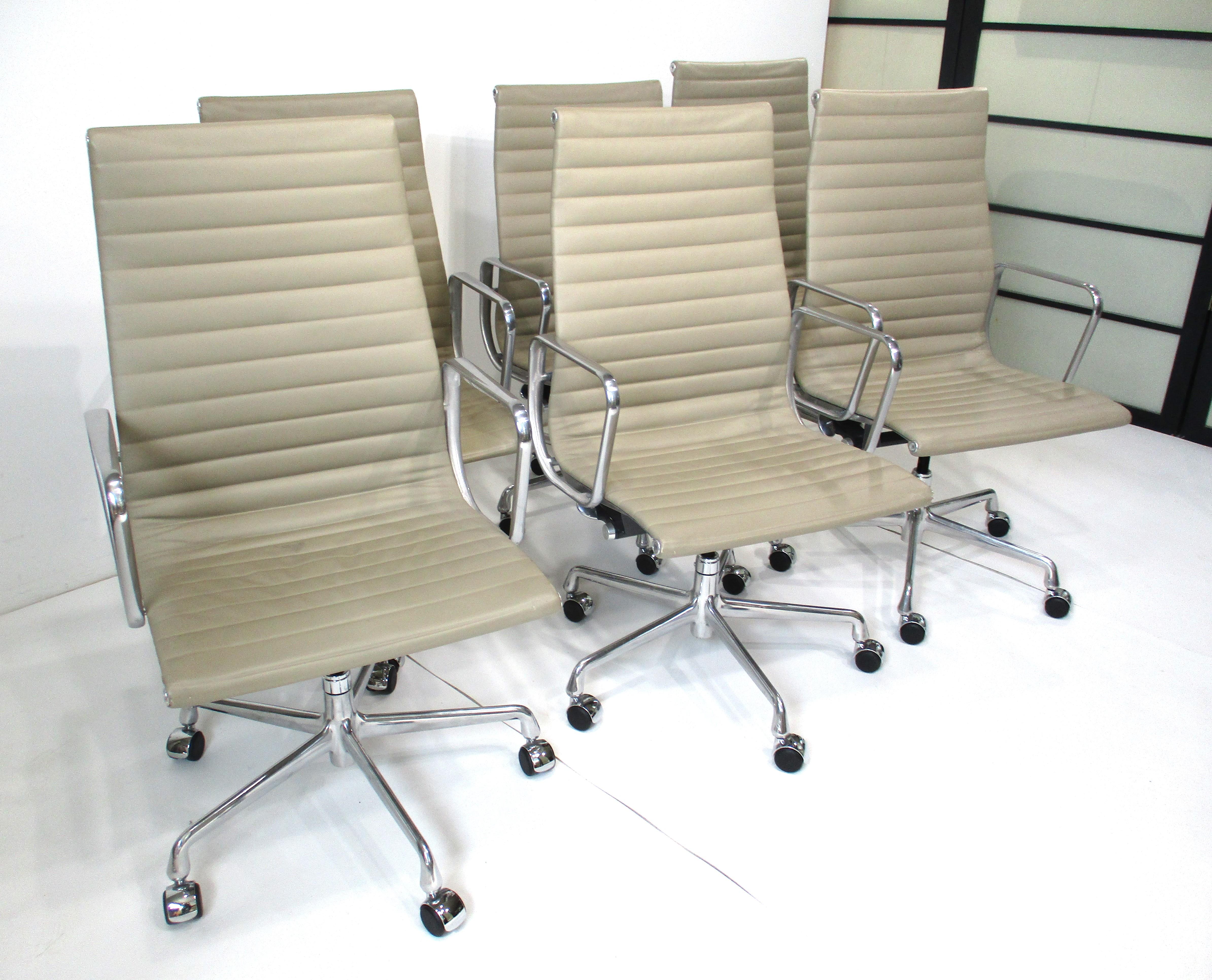 A set of six 50th Anniversary edition 1958 - 2008 executive rolling high back aluminum group chairs . Upholstered in a smooth and soft taupe spinney back leather only for this edition with polished aluminum star bases . These iconic chairs are still