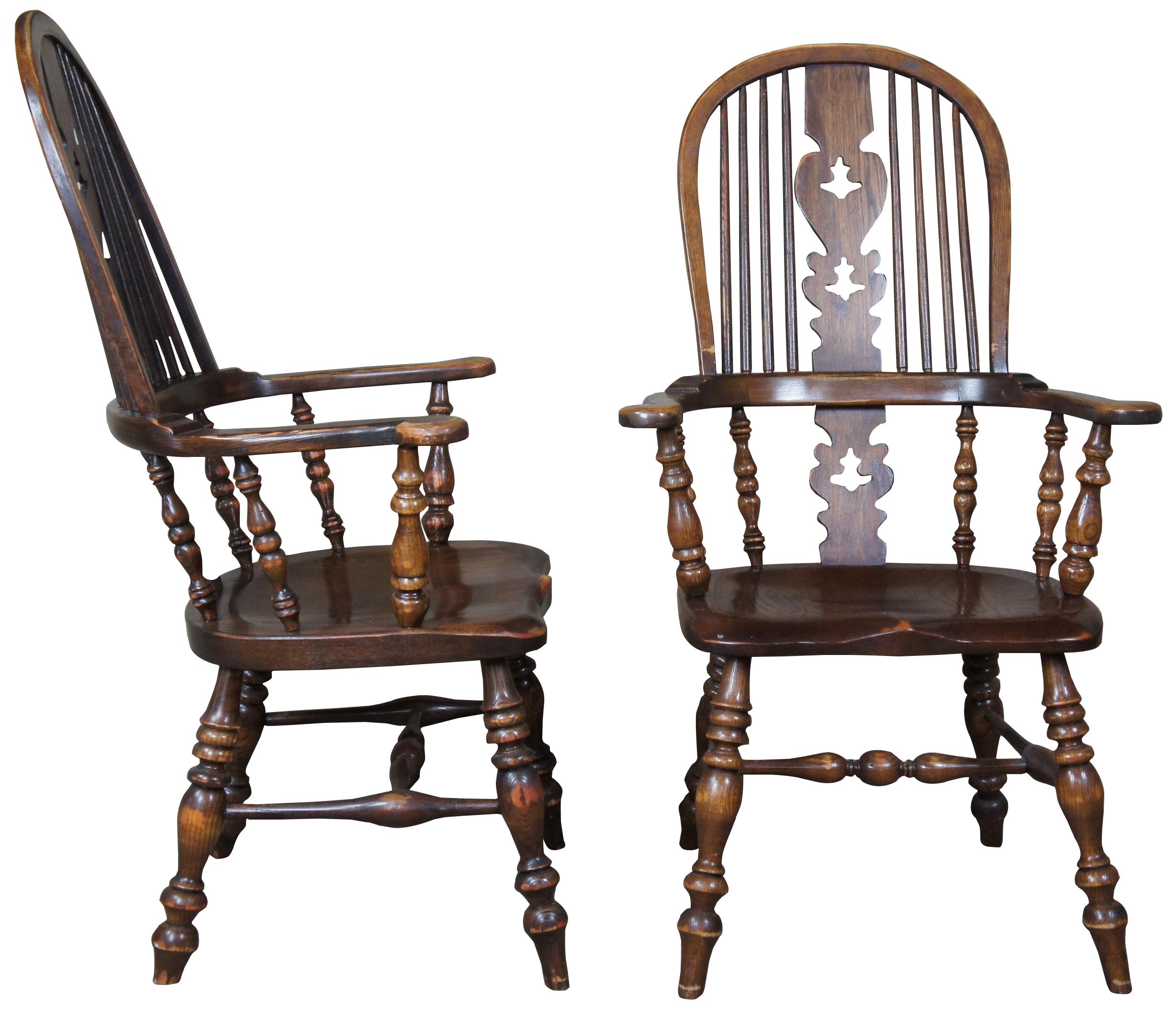 Set of six vintage English Windsor oak dining chairs. Saddle seat and turned baluster supports, circa 1960s-1970s.
 
