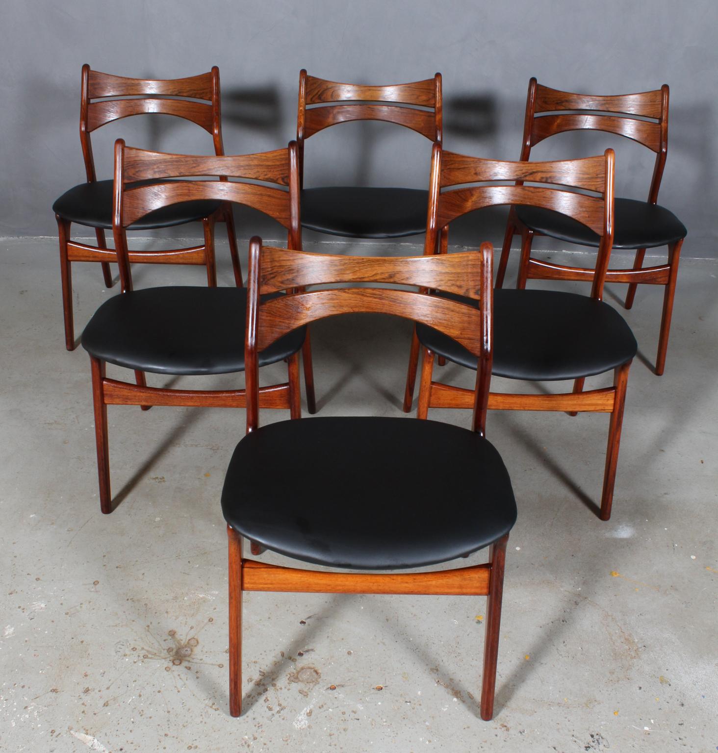 Five Eric Buch chairs with frame of partly solid rosewood.

New upholstered with black semi aniline leather. 

Model 310, made by Chr Christensens Møbelfabrik, Denmark.