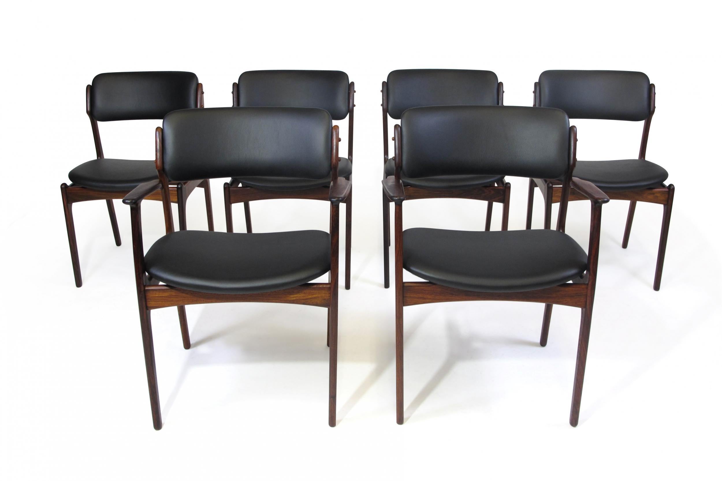 Set of six dining chairs designed by Erik Buck for Poul Dinesen Model 49 & 50. Chairs crafted of solid Brazilian rosewood frames with floating seats and curved back rests newly upholstered in black leather in a soft matte finish. Finely restored by