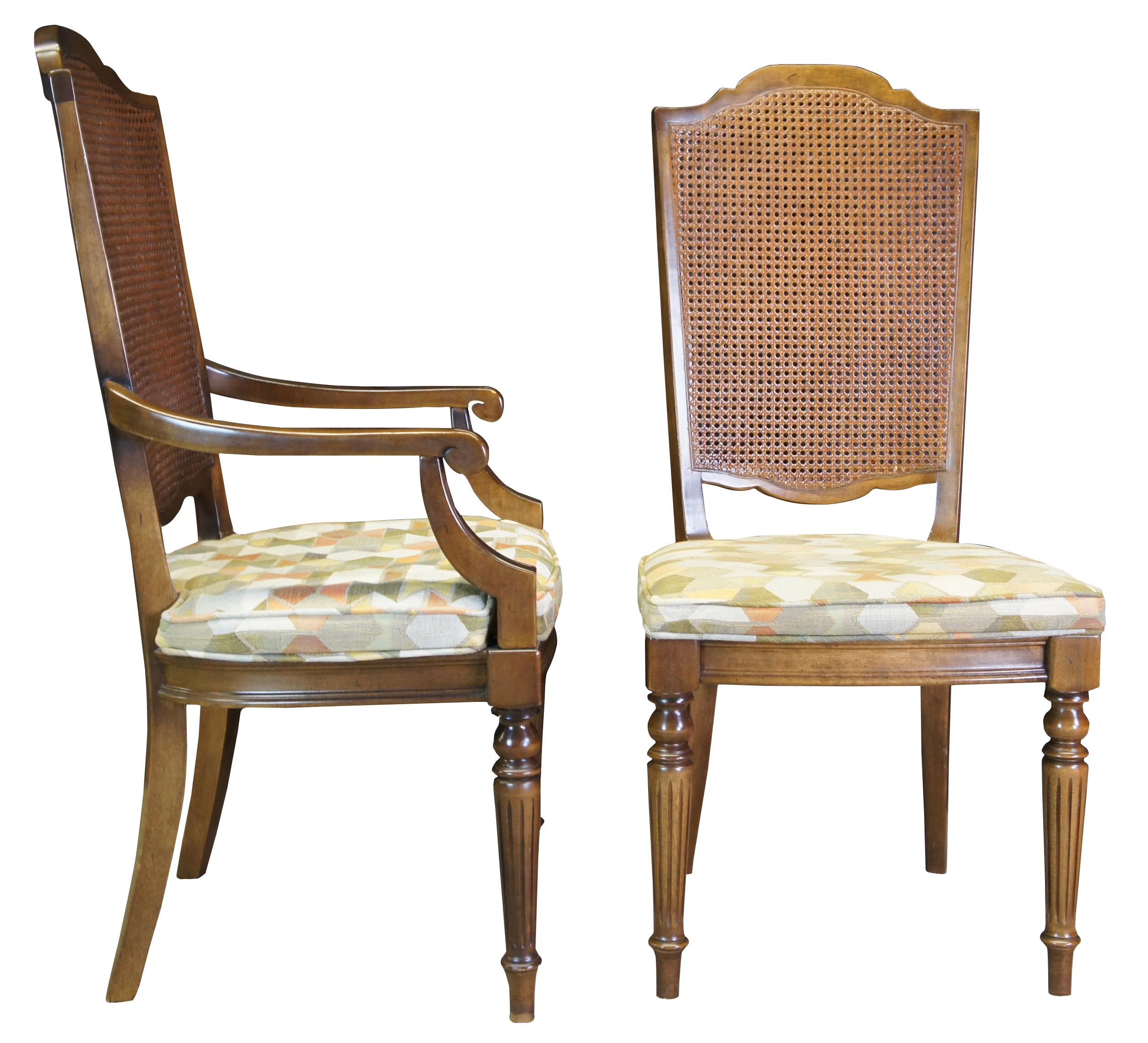 Six Vintage Ethan Allen Classis Manor dining chairs, circa 1970s. Made of solid maple featuring caned back with fluted and tapered accents and geometric / hexagon upholstery. Includes two arms and four sides. 15-6012. A rich blend of French Country