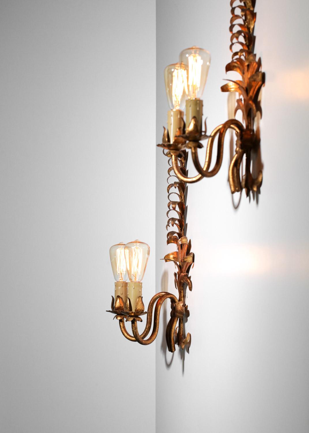 Pair of French sconces from the 50's in baroque style in the taste of Jansen's work. Gilded metal structure with a very decorative vegetal pattern. Very nice vintage condition, E14 LED bulbs recommended.  