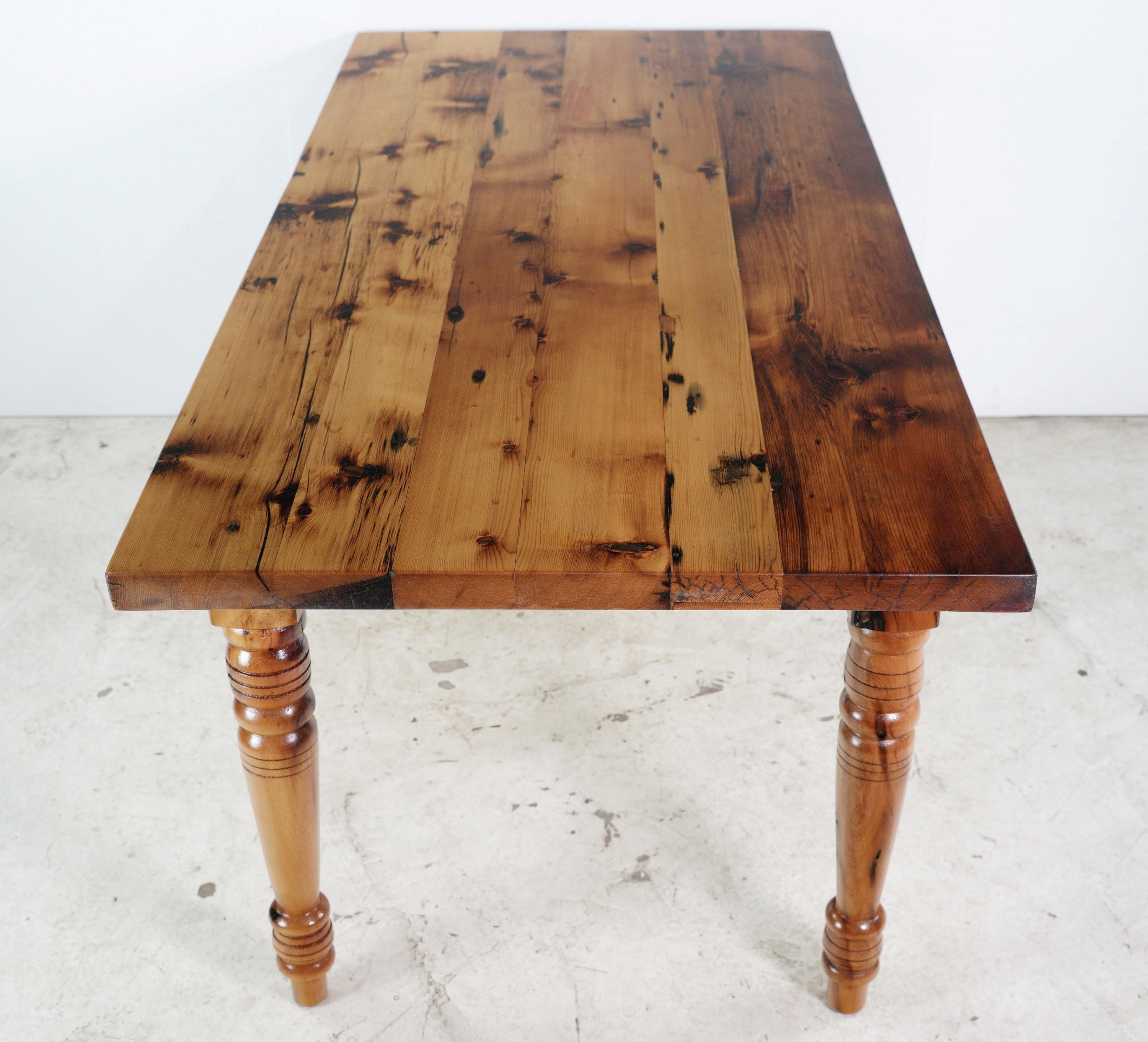 Combining artistry and sustainability, the handcrafted reclaimed pine dining room farm harvest table showcases the charm of turned legs. Its reclaimed pine construction adds character to any dining space with style. his table is ready to ship.