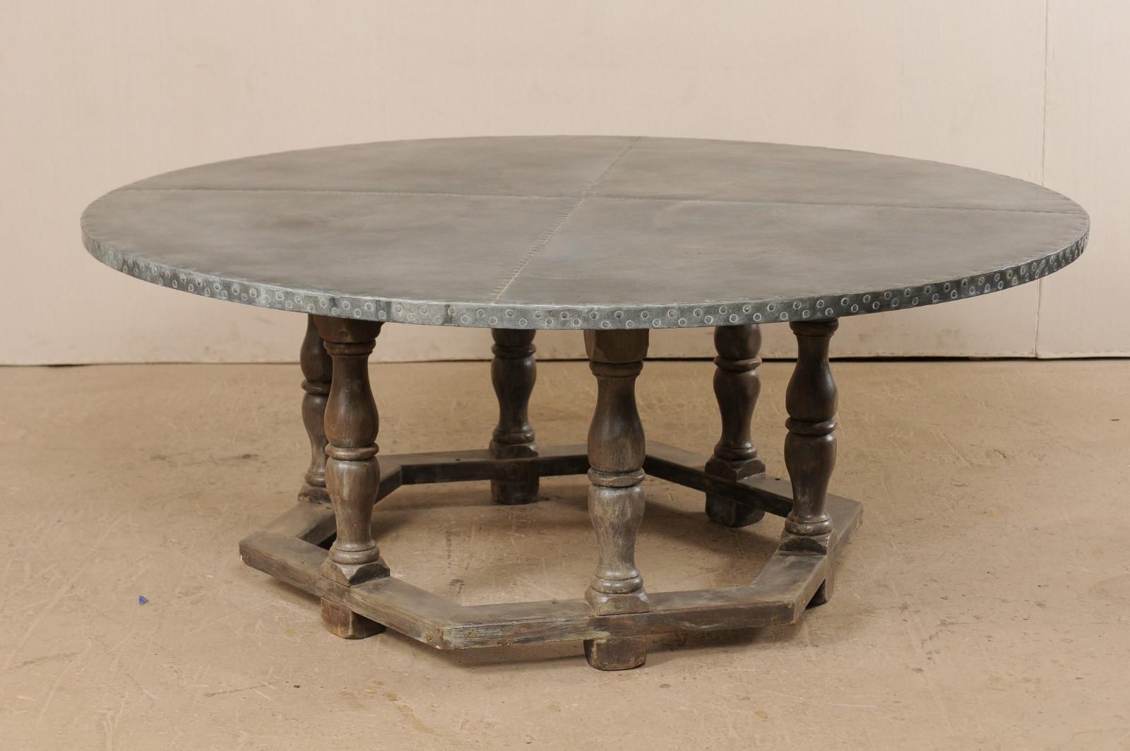 An American painted wood round-shaped dining table with zinc top. This fabulous custom table has been fashioned from the base of an old 1940s school table, with the addition of a newer zinc top. The hexagon-shaped base is comprised of six