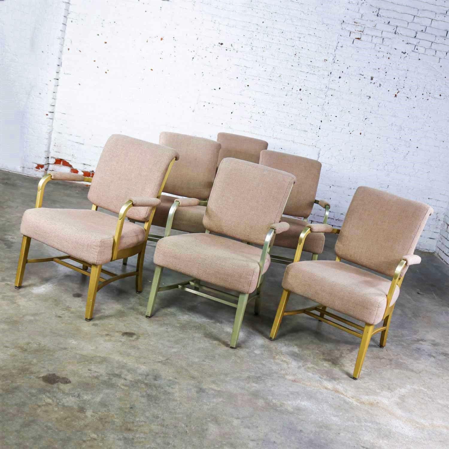 Handsome set of 6 Goodform mid-century machine age and industrial style aluminum armchairs by General Fireproofing Company. Comprised of anodized slightly gold colored aluminum frames and upholstered in a woven beige fabric. They are in wonderful