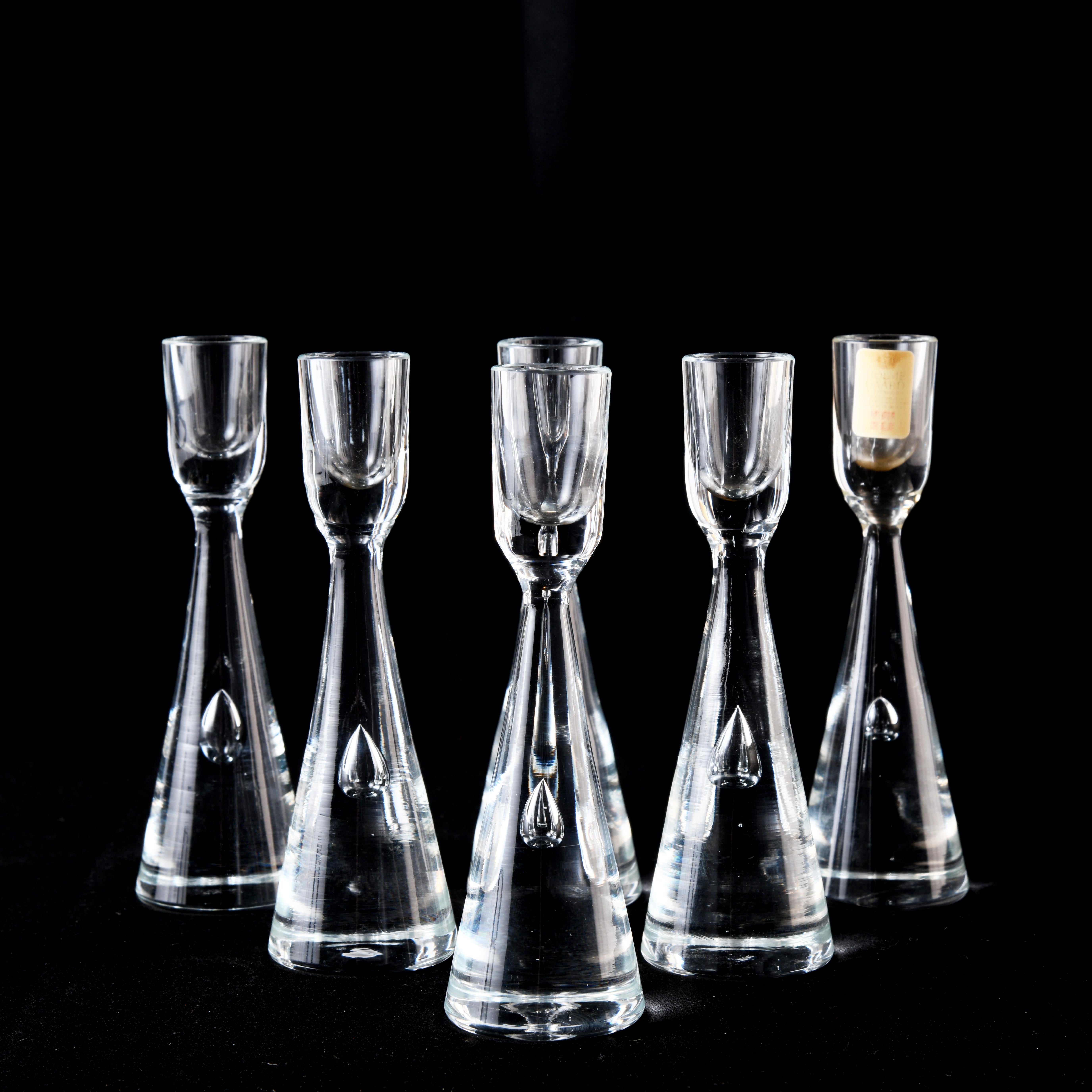 Set of six small glass candleholders (H: 12cm) with an air bubble, designed by Bent Severin (1925-2012) for the Danish glass company Holmegaard in 1957. These candleholders are part of the 