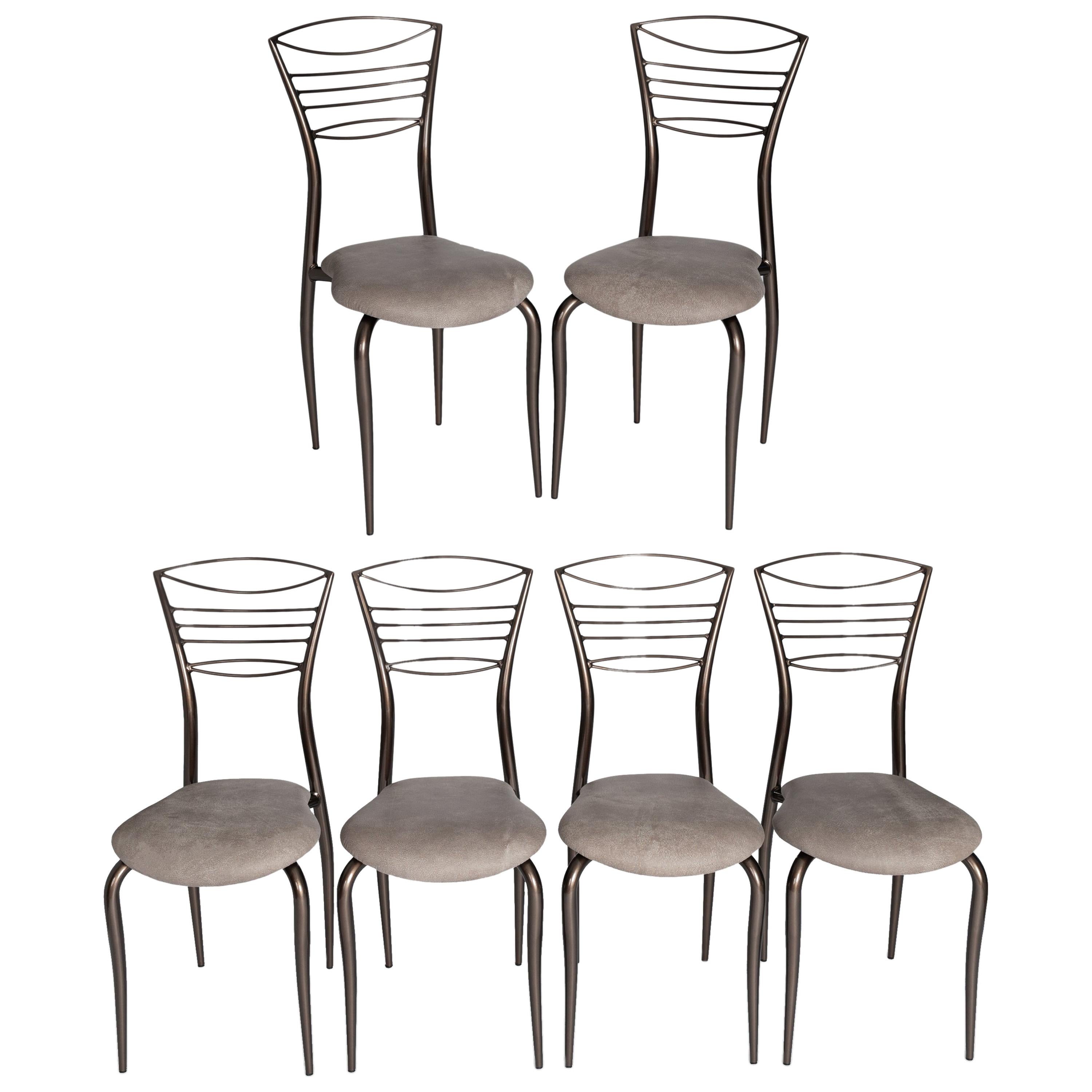 6 delicate and light-footed midcentury designed chairs.
Cast iron in shiny metallic brown-taupe-colored paint, taupe-colored leather in a matt vintage look.
The lines show soft curves on the leg design as well as the seat cushion and the