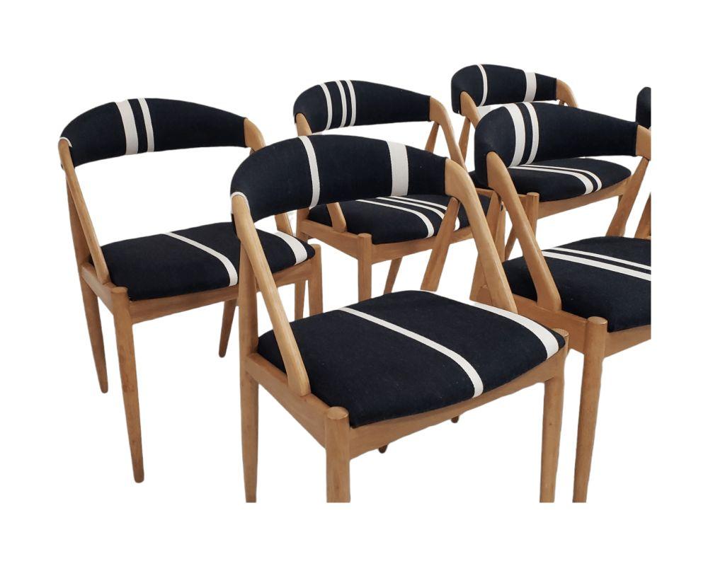 Kai Kristiansen solid white oak dining chairs, model 31, for Schou Andersen, Denmark. These are very comfortable dining chairs with supportive backs. The seat frame are constructed of a wood frame with new rubber strap supports covered in foam and