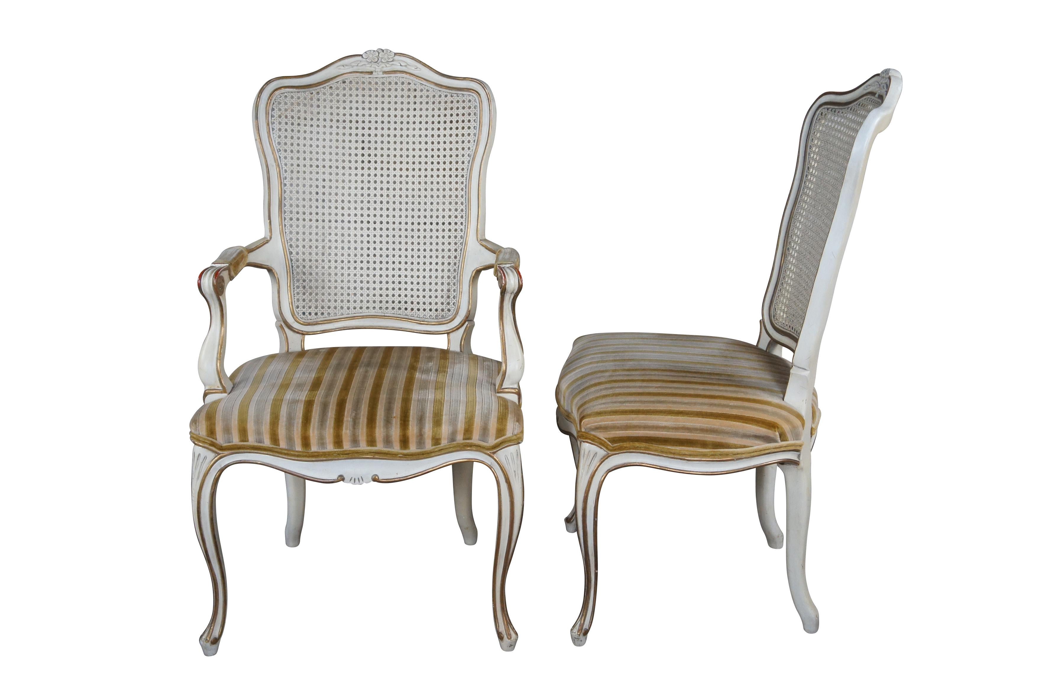 Vintage set of six Kindel Furniture Co. french provincial dining chairs featuring serpentine form with caned back, fauteuil arms, white and gold painted accents and striped velvet fabric.  Made by Michigan Chair Co of Grand Rapids, circa