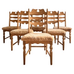 6 Kjærnulf dining chairs in oak and reupholstered honey colored sheep skin.