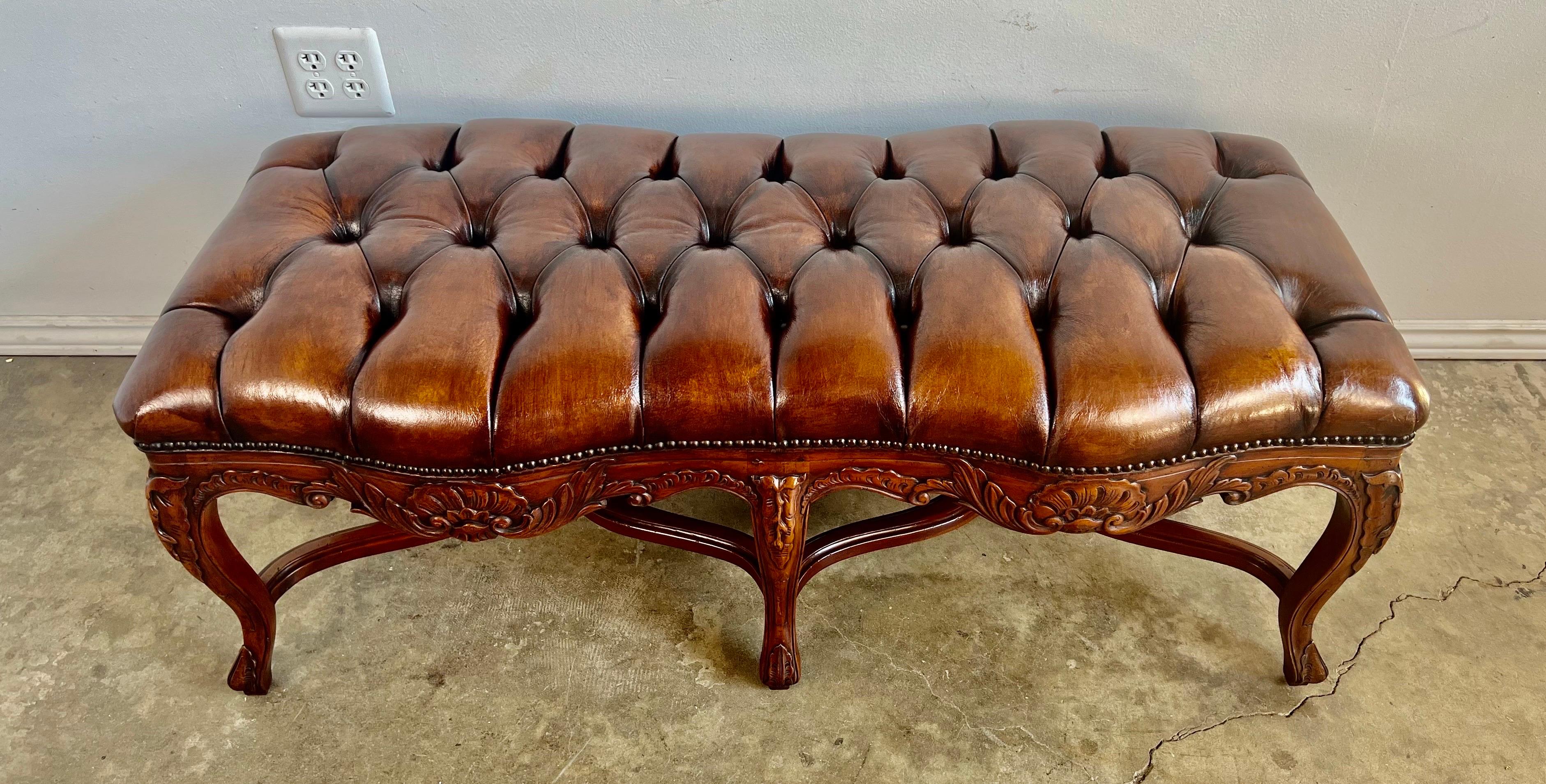 Early 20th century French Louis XV style carved walnut bench. The bench stands on six cabriole legs with rams head feet. A double 