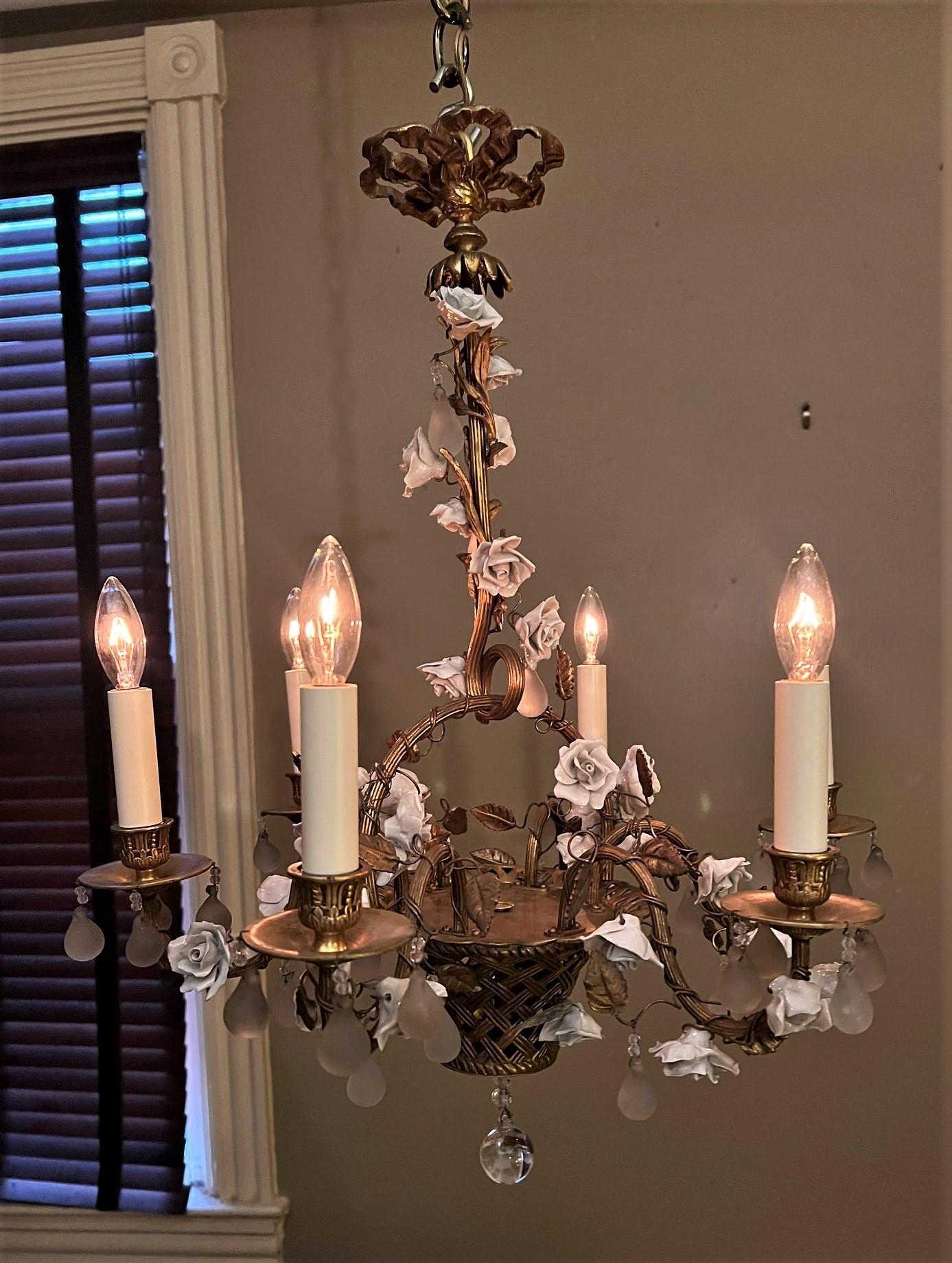 This Louis XVI style chandelier is a copy of the fixtures that often hung in boudoirs of ladies of fashion in mid-18th Century France. Today these chandeliers are perfect for anywhere in the house that real beauty and charm is desired. The basket,