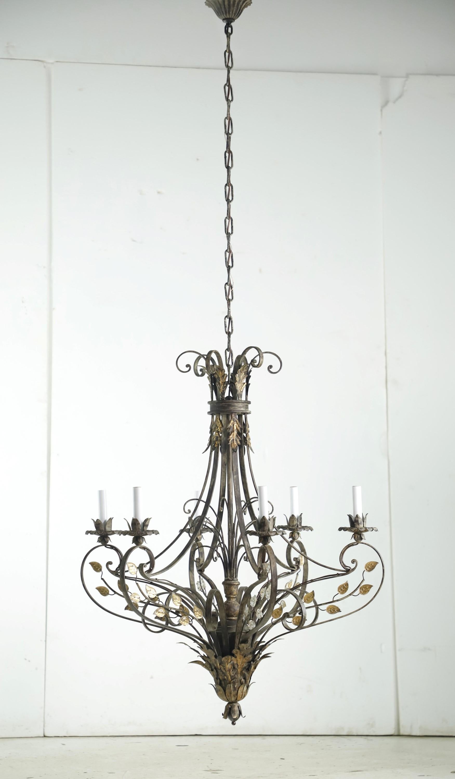 Wrought iron chandelier with crystal leaves and floral details. Black and gilt finish. Takes six standard candelabra light bulbs. Cleaned and restored. Please note, this item is located in our Los Angeles location.