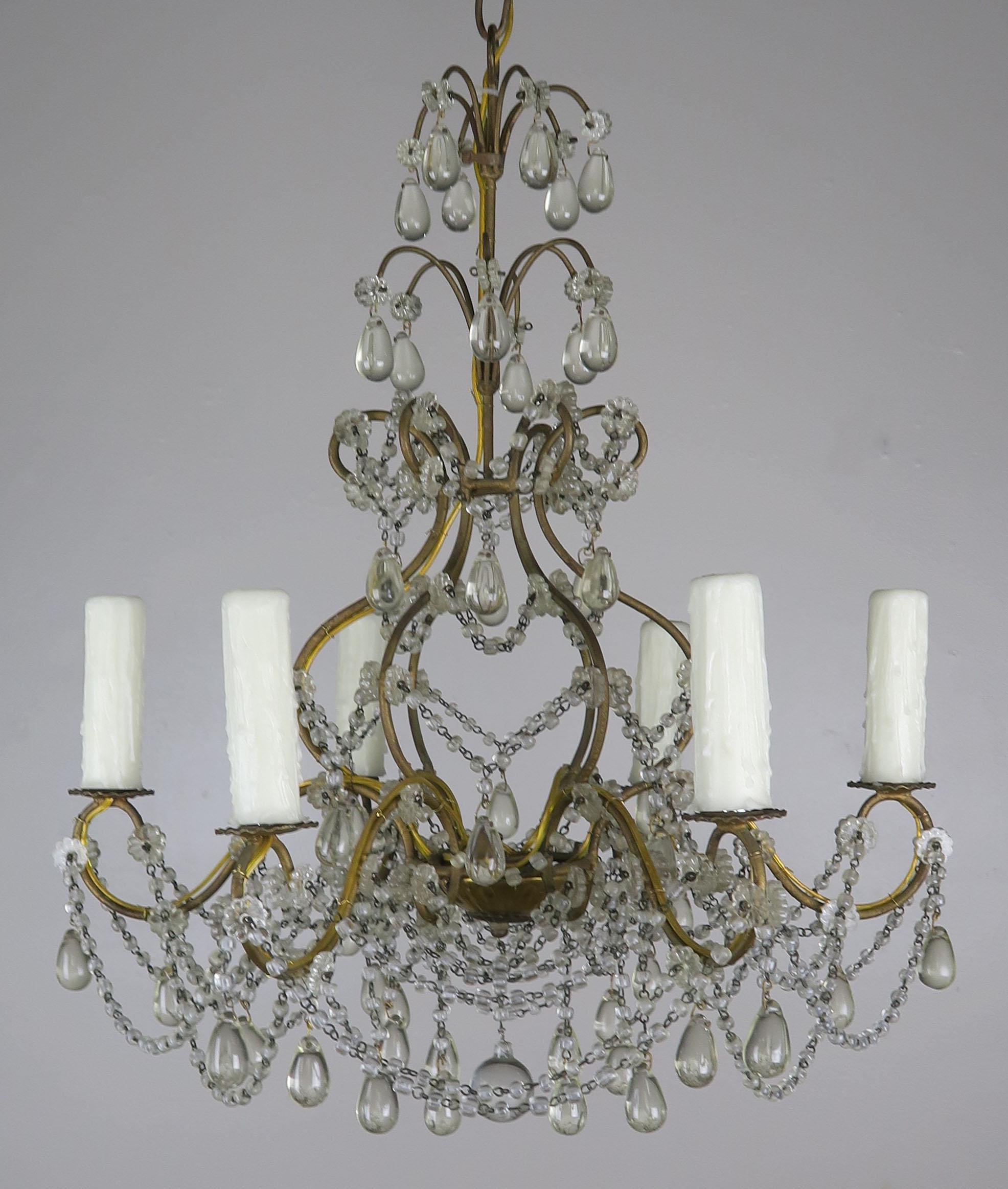 (6) light Italian gilt metal framed chandelier adorned with garlands of macaroni beads and tear shaped drops. The fixture is newly rewired with cream colored drip wax candle covers. Includes chain and canopy.