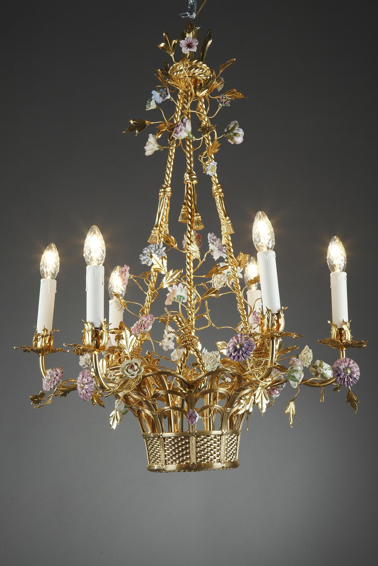 Napoleon III ormolu chandelier in Rococo style. The six arms of light coil out from an over-flowing basket of flowers, crafted in porcelain in the taste of Meissen manufactory. The stunning symphony of flowers and flourishes accentuate the basket
