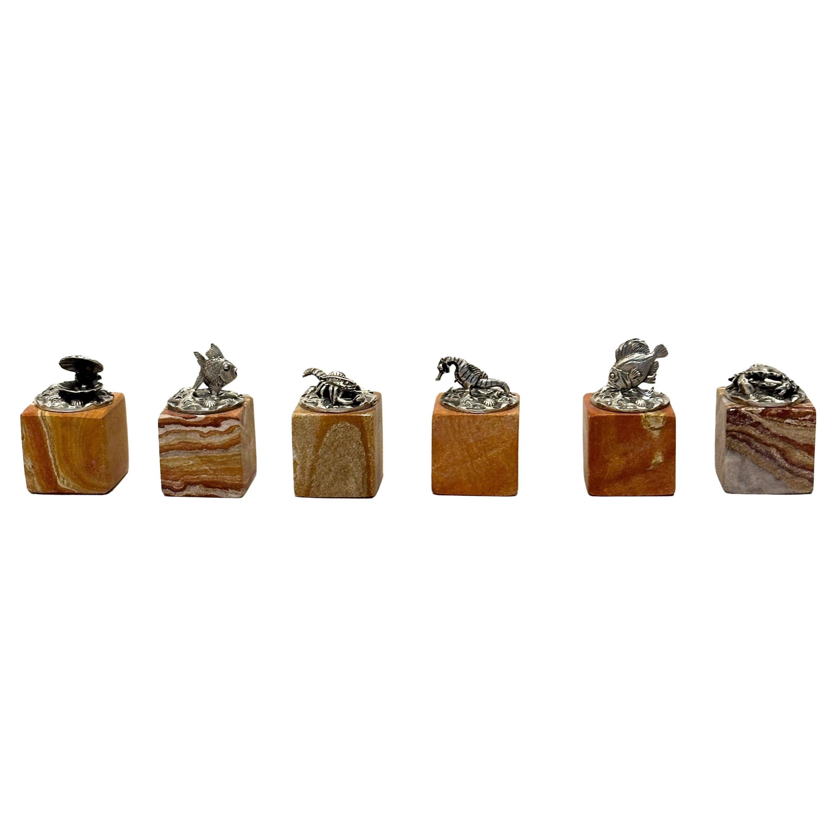 This rare set of six place card holders by M. Buccellati is a tribute to the marine world, captured through the elegance of Italian silversmithing. Each piece is finely crafted in sterling silver and depicts a distinctive sea creature: a shell, a