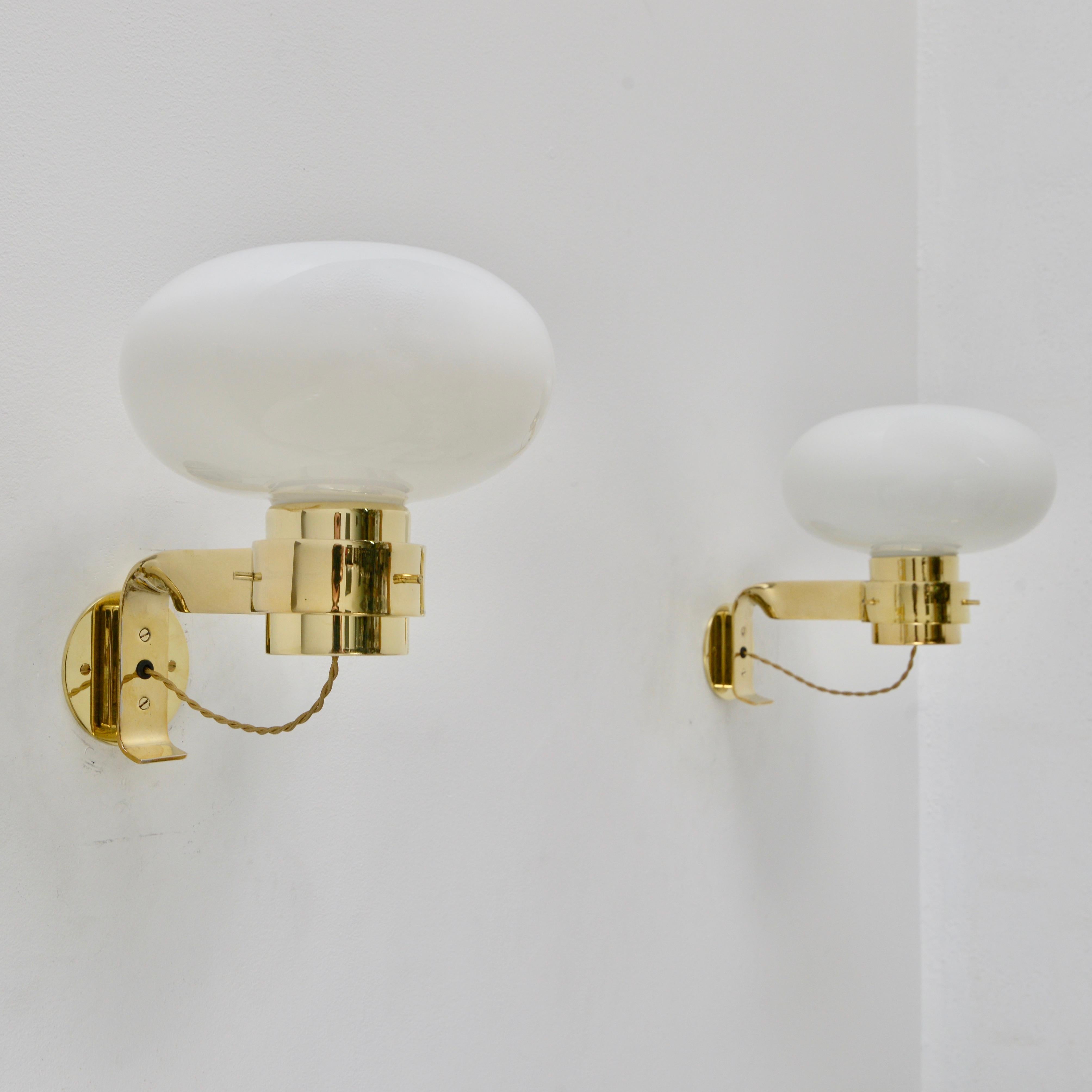 (2) Beautiful Martinelli Luce sconces from 1960s Italy. Made from polished un-lacquered brass and opal glass. The finish will patina over time. Rewired for use in the US with (1) E26 medium based socket per sconce. Light bulbs included with order.