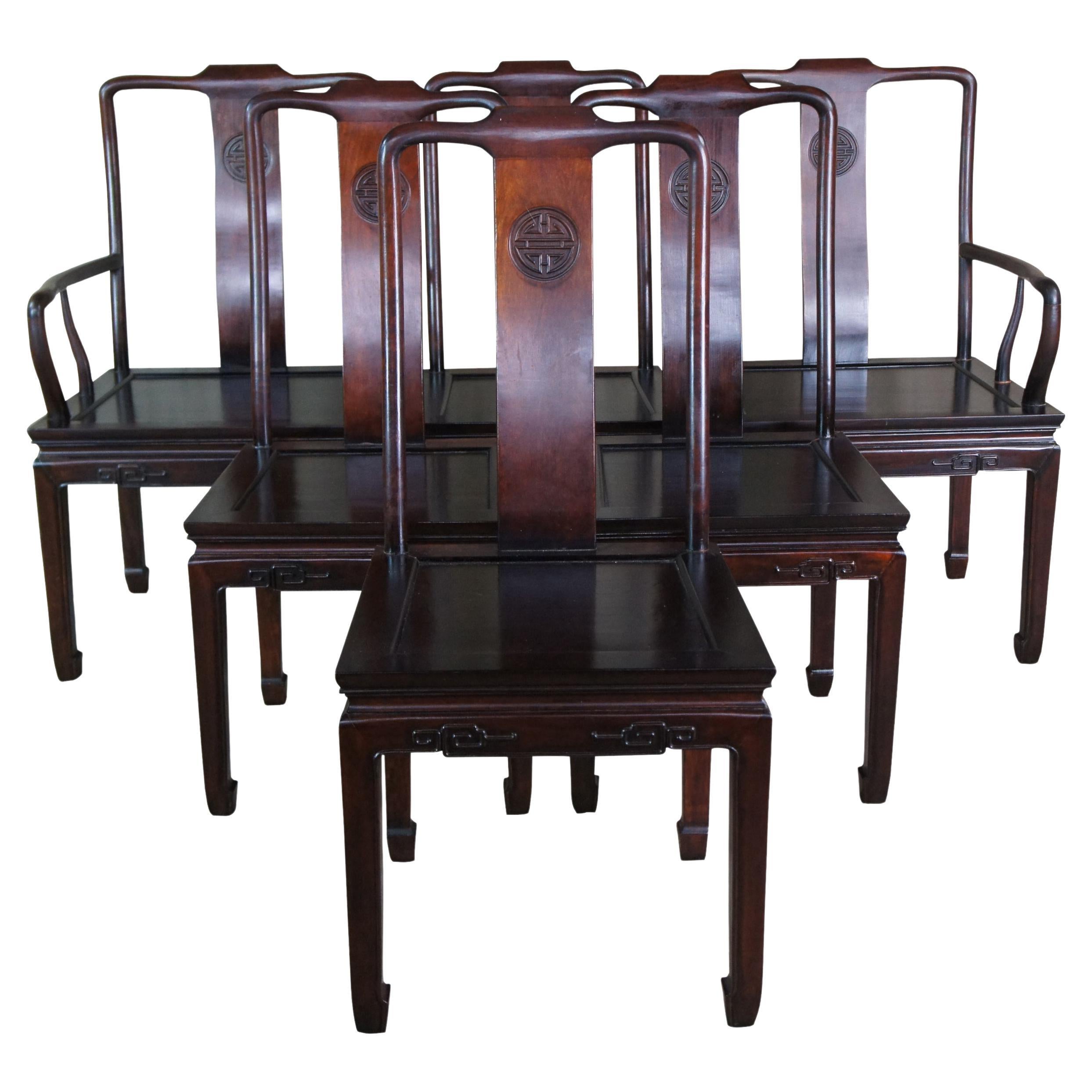 Six mid 20th century Chinese Ming style dining chairs. Made of rosewood featuring bentwood form with imperial crest and carved accents. Silk cushions included.

Measures: 22