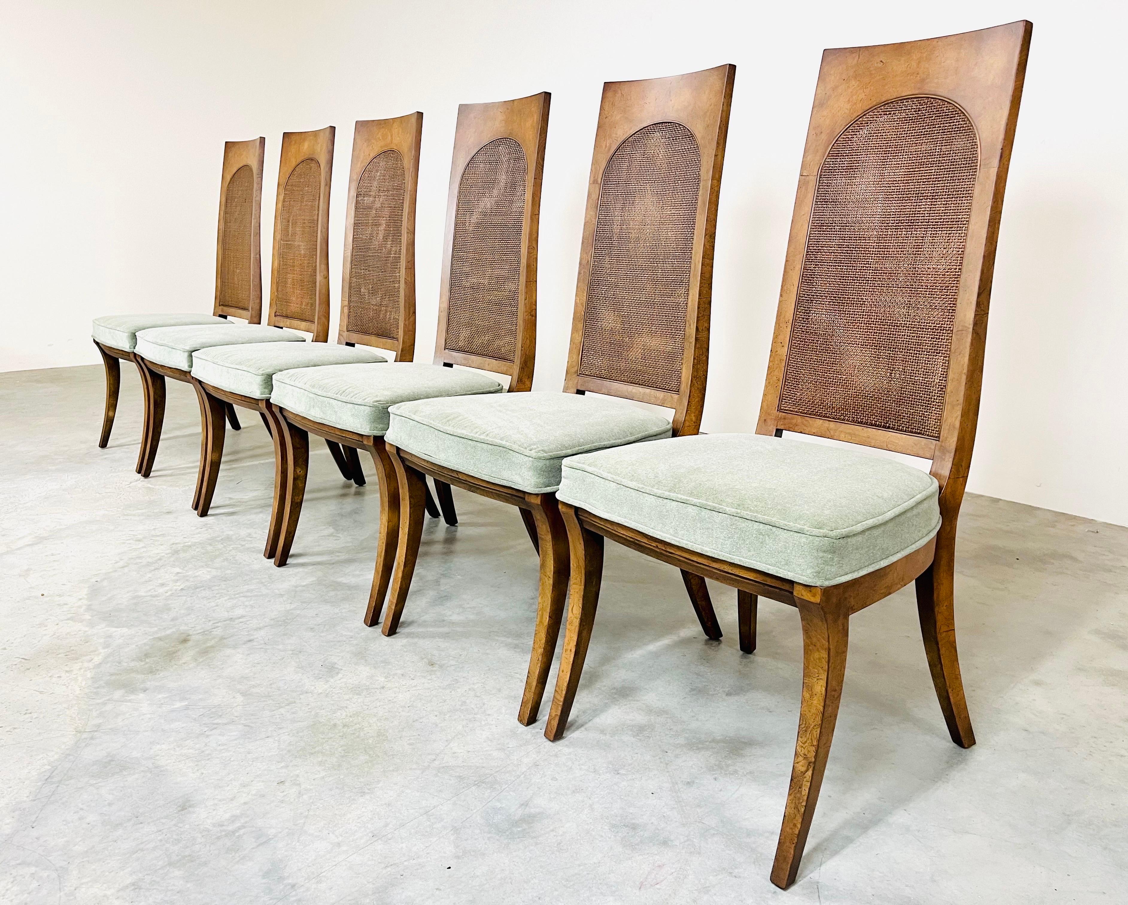 A beautiful set of 6 midcentury Klismos leg dining chairs having bird’s-eye maple frames, double cane backrests and medium green mohair seats. 
 All chairs are in excellent condition having been refinished with the seats reupholstered with fresh