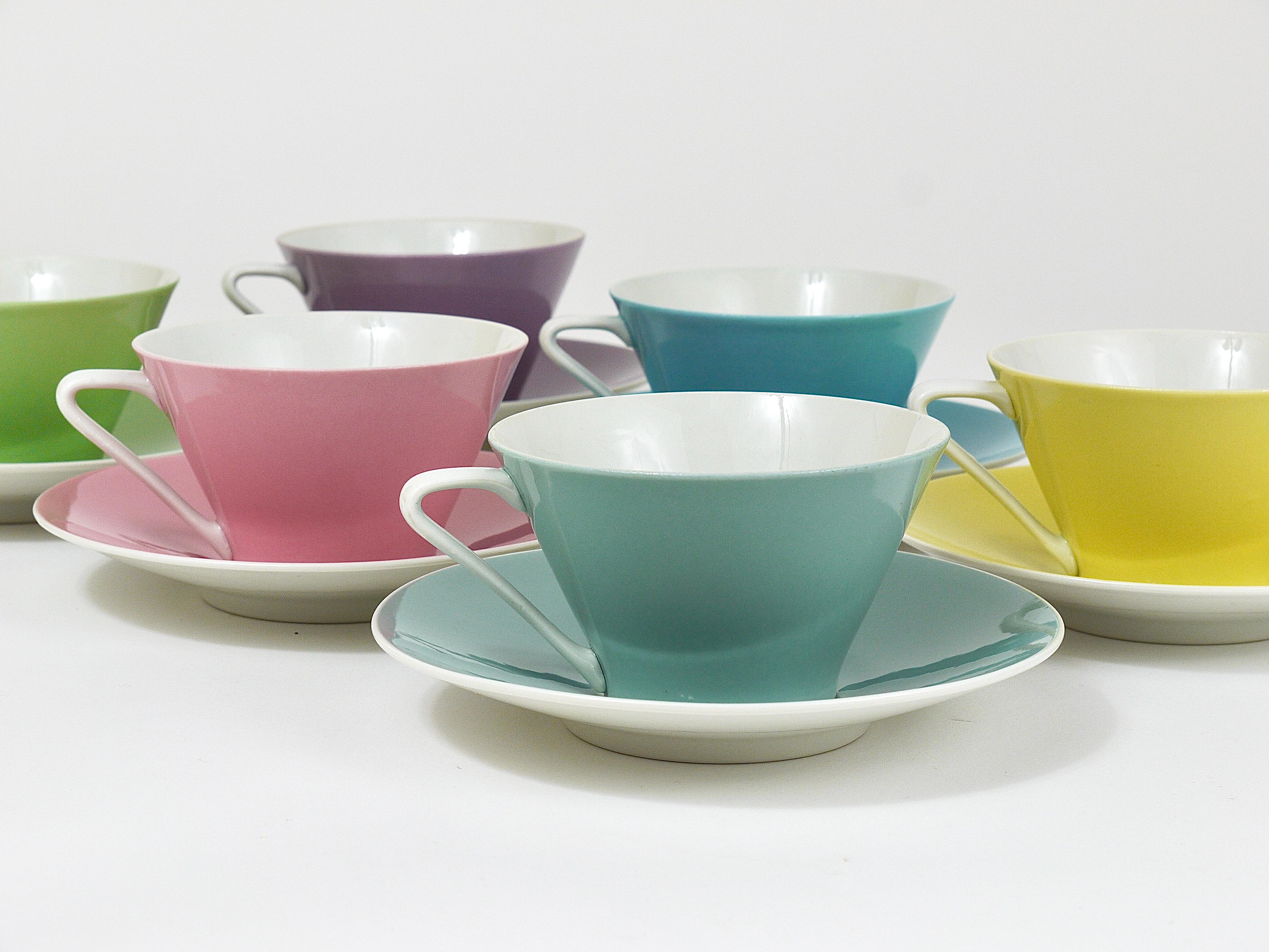 A set of six charming conical coffee cups and saucers from the „Daisy“-series, made of thin, fine china in six different lovely pastel colors, yellow, light blue, light green, bluegray, pink/rosé and lilac. Made in the 1950s by Lilien Porzellan