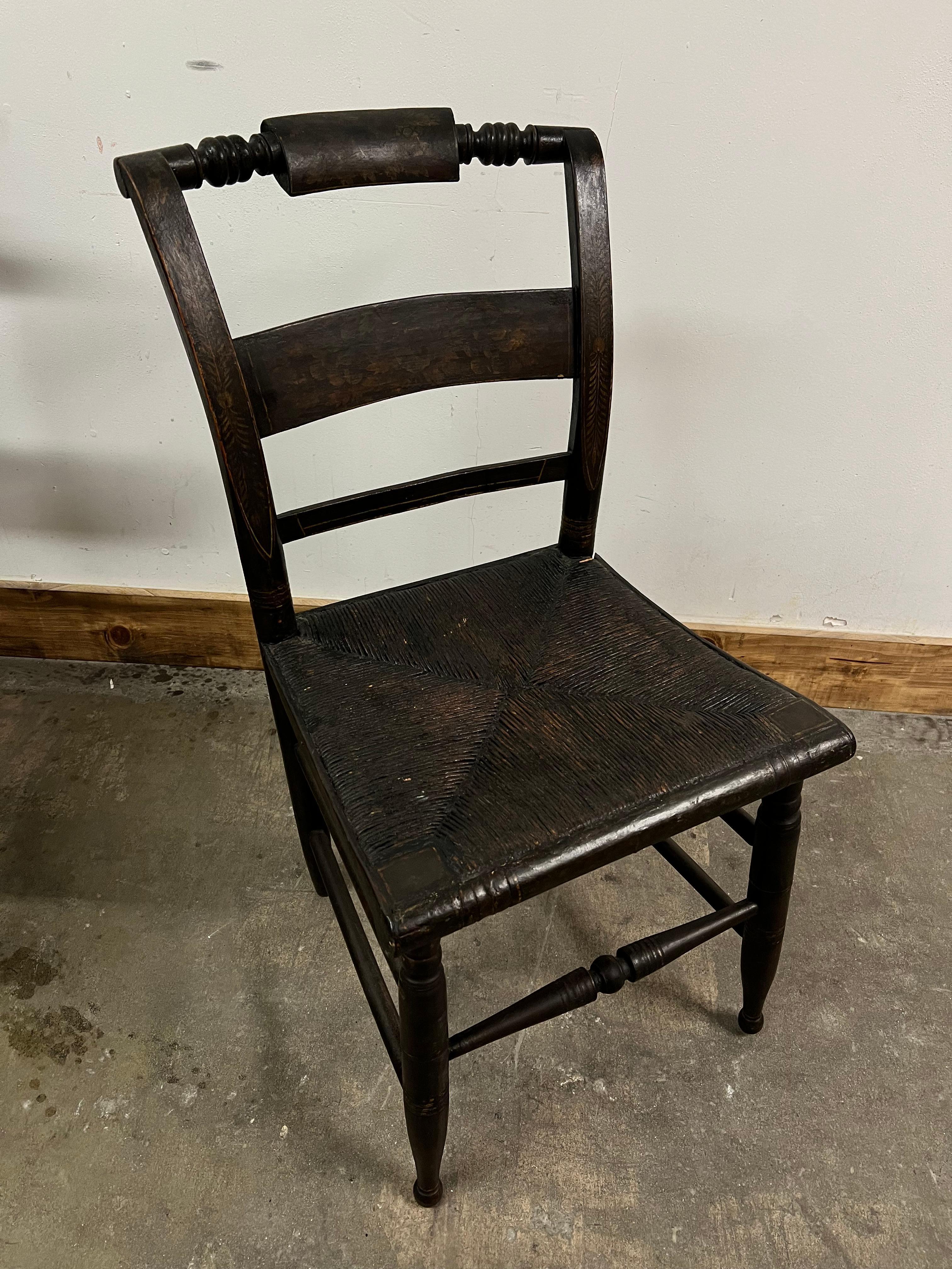 6 Wooden Hitchcock Style chairs with a deep dark rich color. Hand Stenciled design with heavy woven rush seats... the patination of the chairs is very rich showing years of wonderful age.

The 6 are in very good condition considering age and would