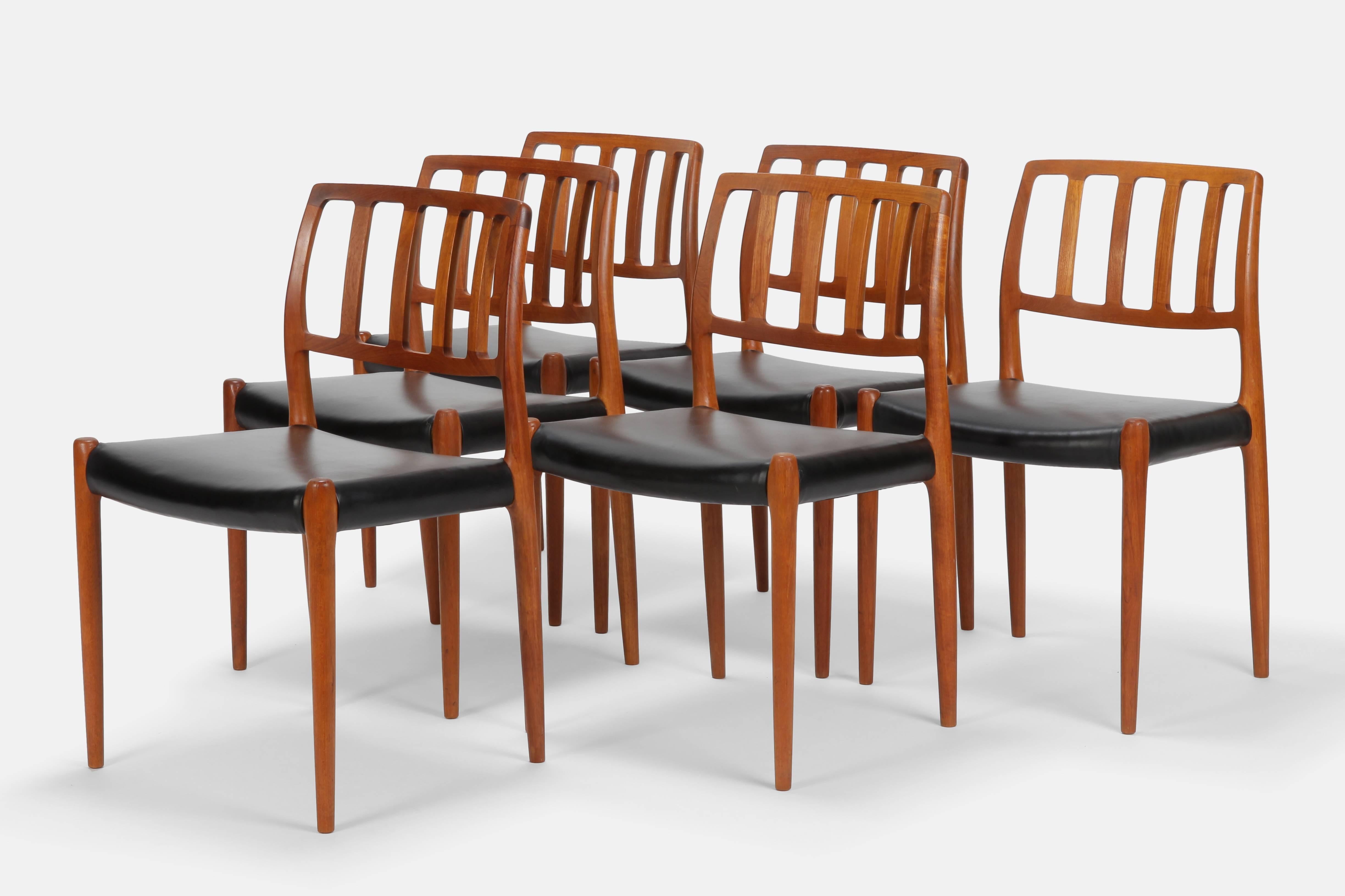 Six Niels Otto Møller dining chairs model 83 manufactured by J.L. Møllers Møbelfabrik in the 1970s in Denmark. Crafted in solid teakwood, the frames have a simple, elegant wood grain and a warm color. Their organic shape and the fine black leather