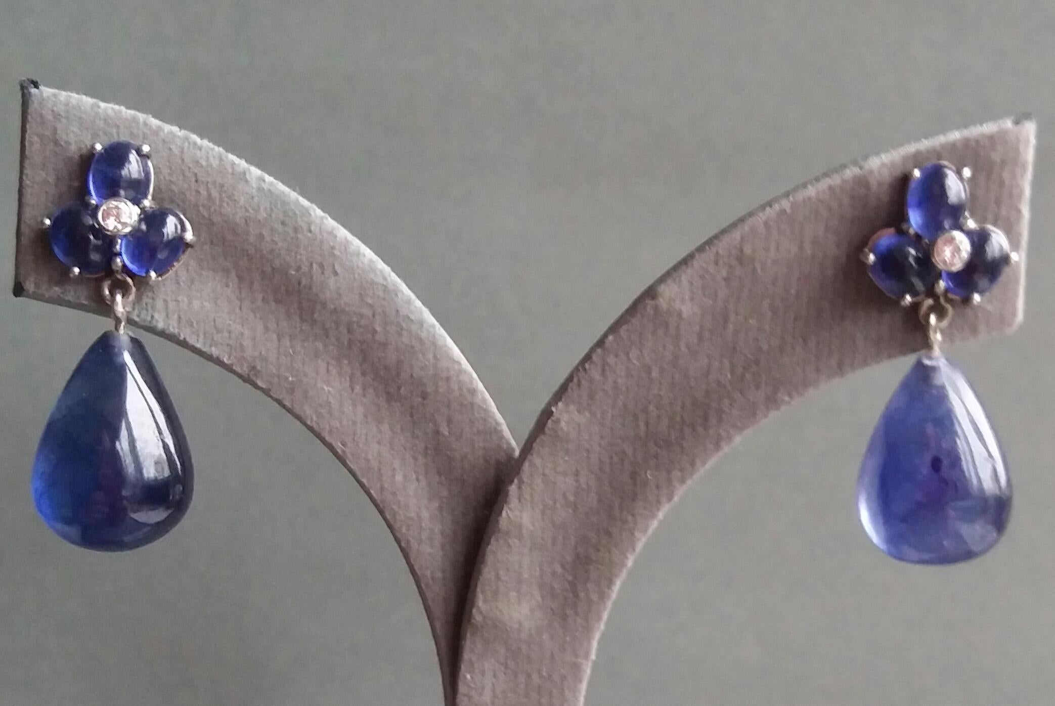 Elegant and completely handmade Earrings consisting of an upper part of 6 oval shape Blue Sapphire cabs of 4 mm x 5 mm set together in 14 Kt yellow gold with 2 small diamonds in the center, at the bottom 2 nice Pear Shape Natural Blue Sapphires