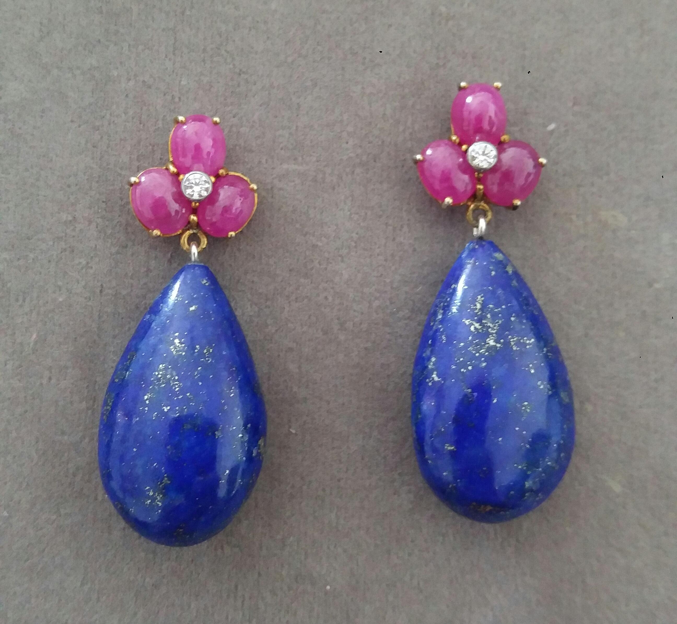 Elegant and completely handmade Earrings consisting of an upper part of 6 oval shape Ruby cabs of 4 mm x 5 mm set together in 14 Kt yellow gold with 2 small diamonds in the center, at the bottom 2 nice Pear Shape Natural Lapis Lazuli measuring 14 mm
