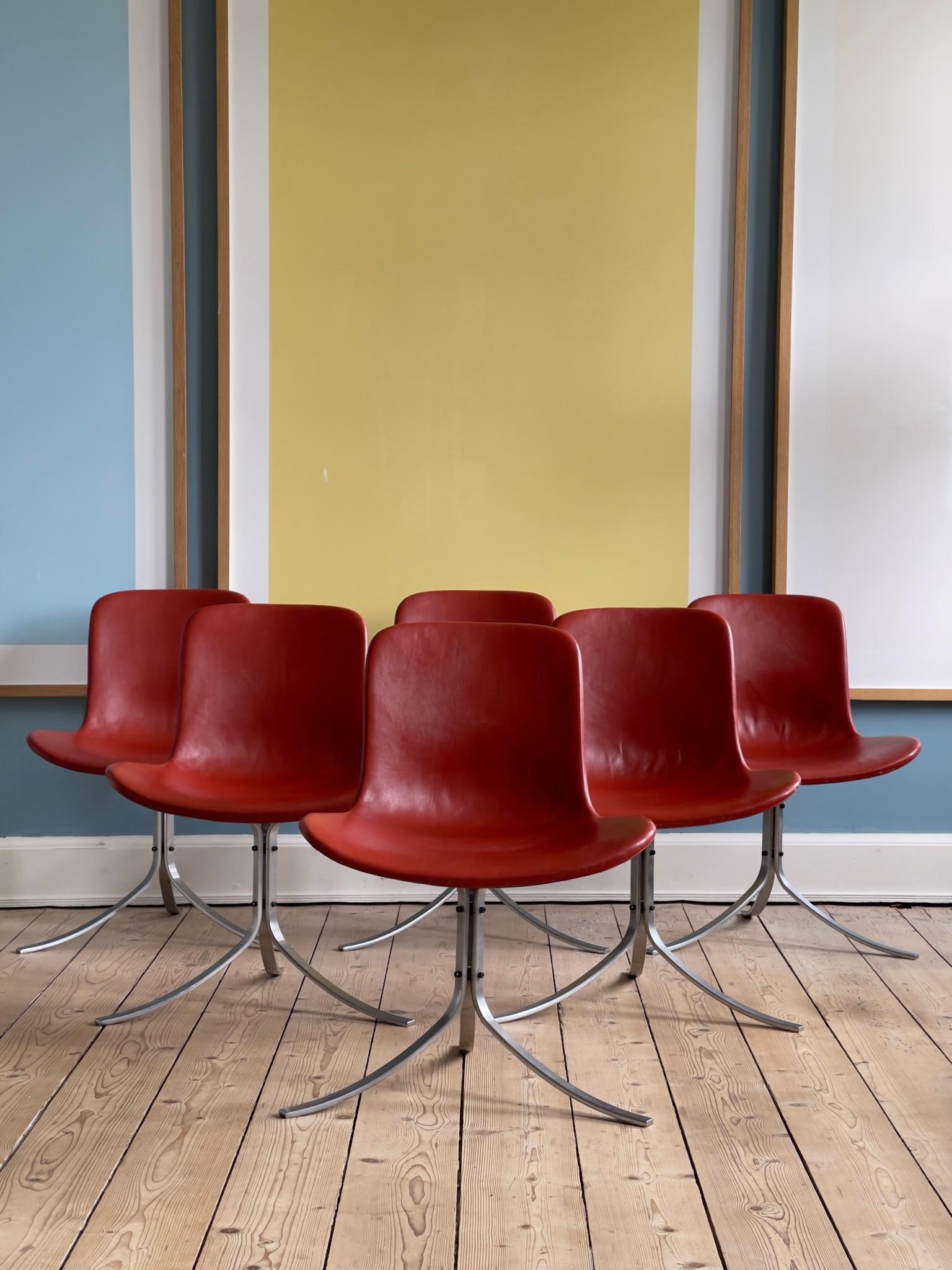 A suite of 6 beautifully patinated dining chairs PK 9 design by Poul Kjaerholm in 1960. It's construction is made of spring steel, the seating is covered with burgundy red leather. Labeled Fritz Hansen.

