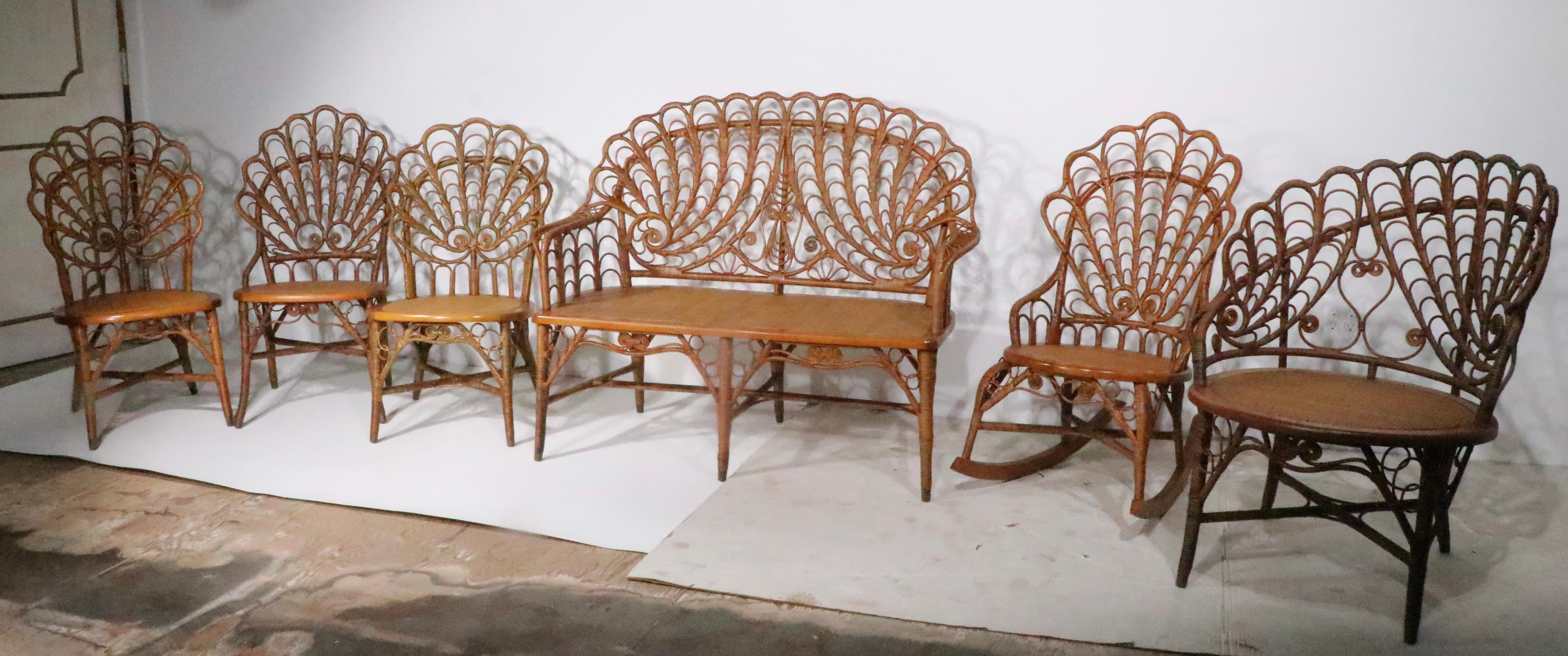 Incredible set of six antique wicker  pieces by Heywood Brothers, circa 1890's. This rare set consists of three side chairs, one rocking chair, one lounge chair and one loveseat settee sofa. The set is in exceptional original condition, showing