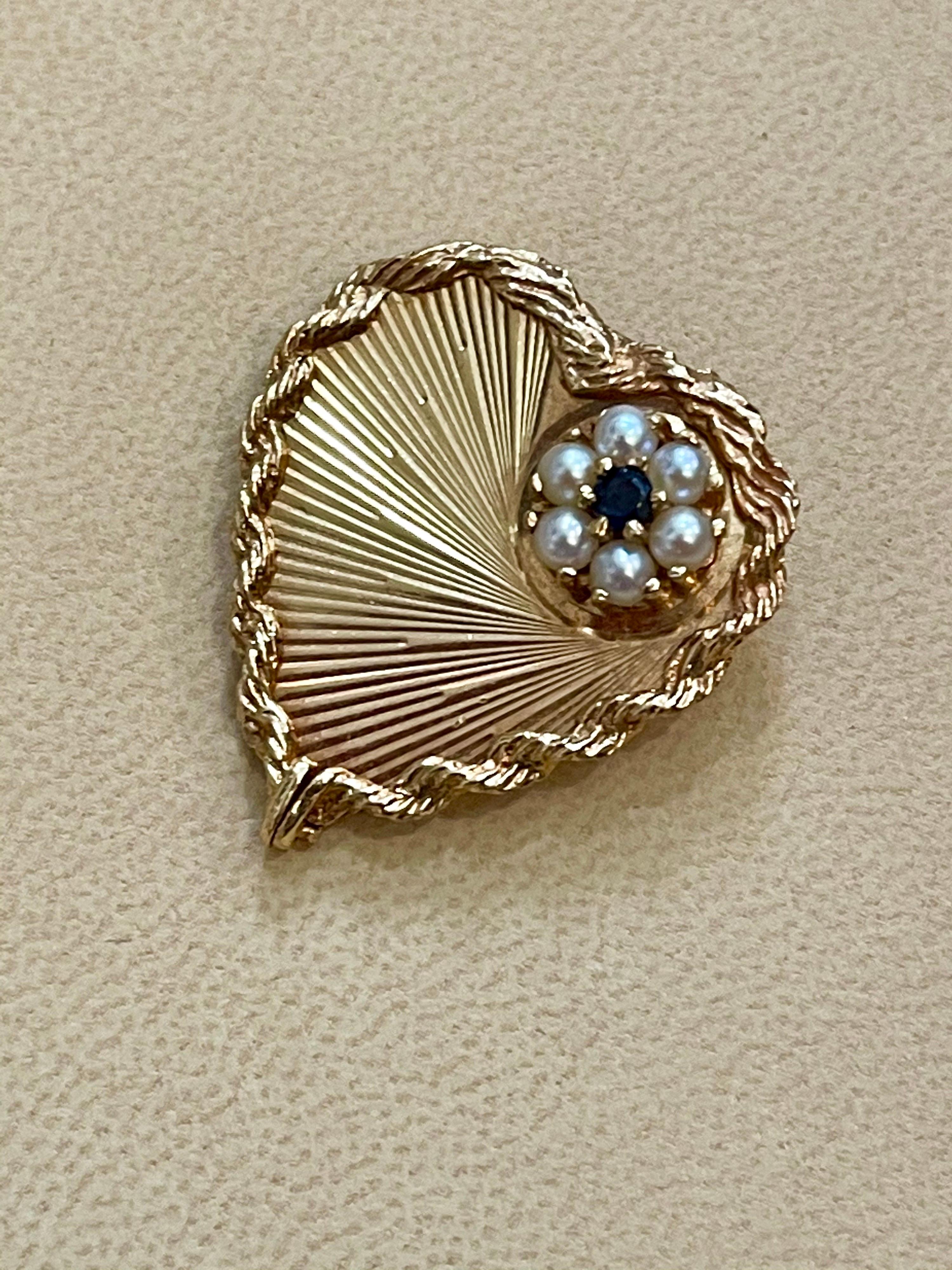 6 Pearl & Sapphire  Heart Shaped 14 Karat Gold Pin or Broach, Affordable, Estate
A beautiful heart shape with folded lace trim and a flower made out of 6 natural pearls which has a round tiny sapphire in the middle .
Very affordable clearance price