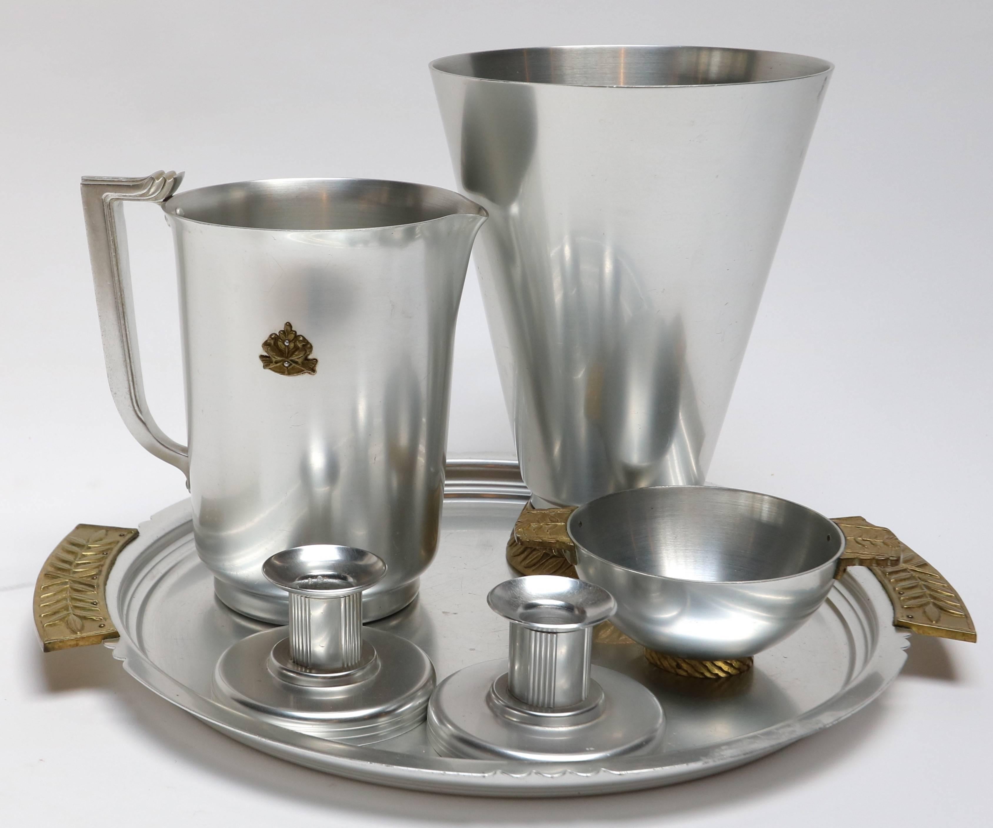 Aluminium and brass pieces table accessories by Kensington, including vase (H x D = 10