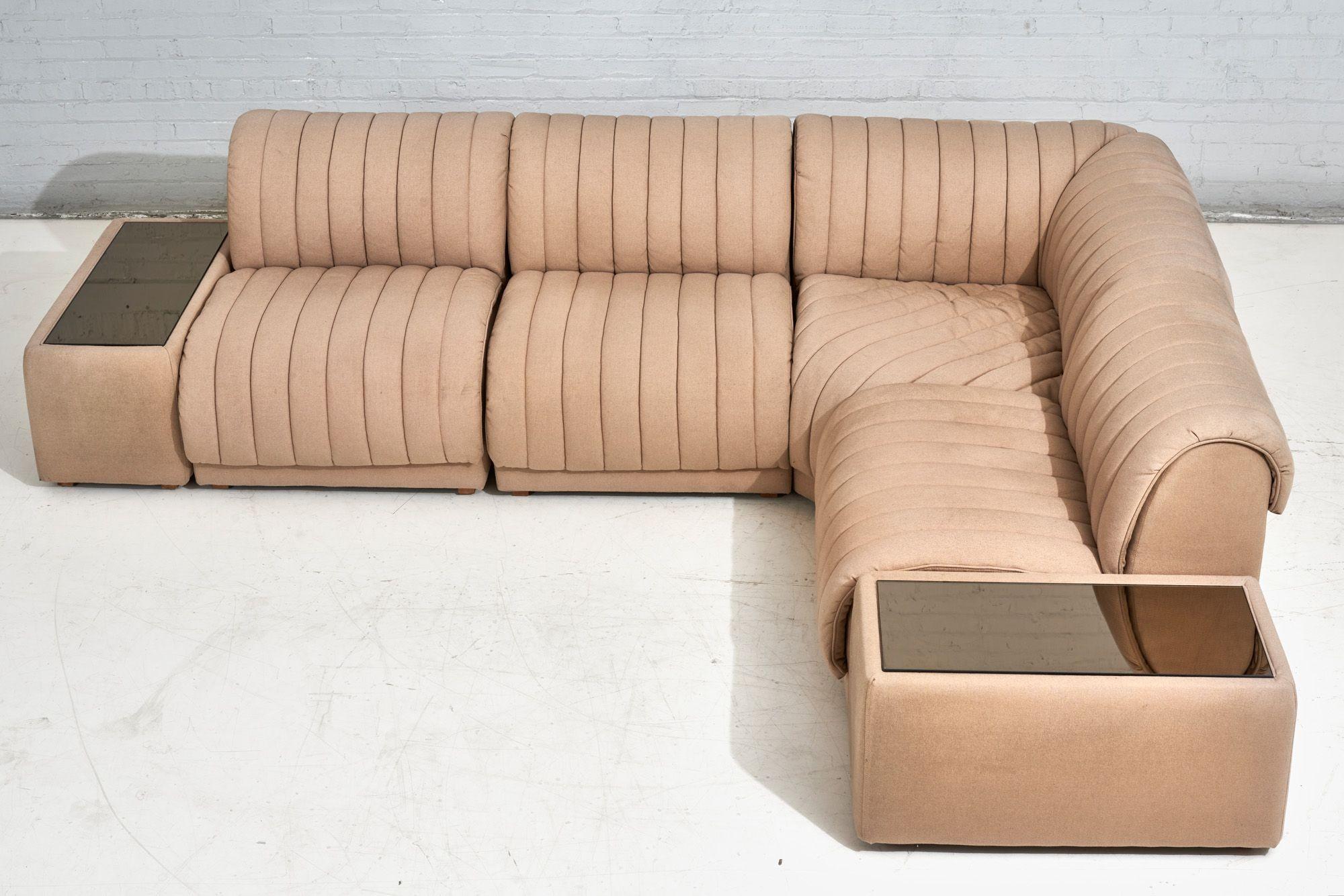 6 piece modular channel tufted Berhnardt sectional with end tables and smoked glass on top. Original upholstery in great condition.