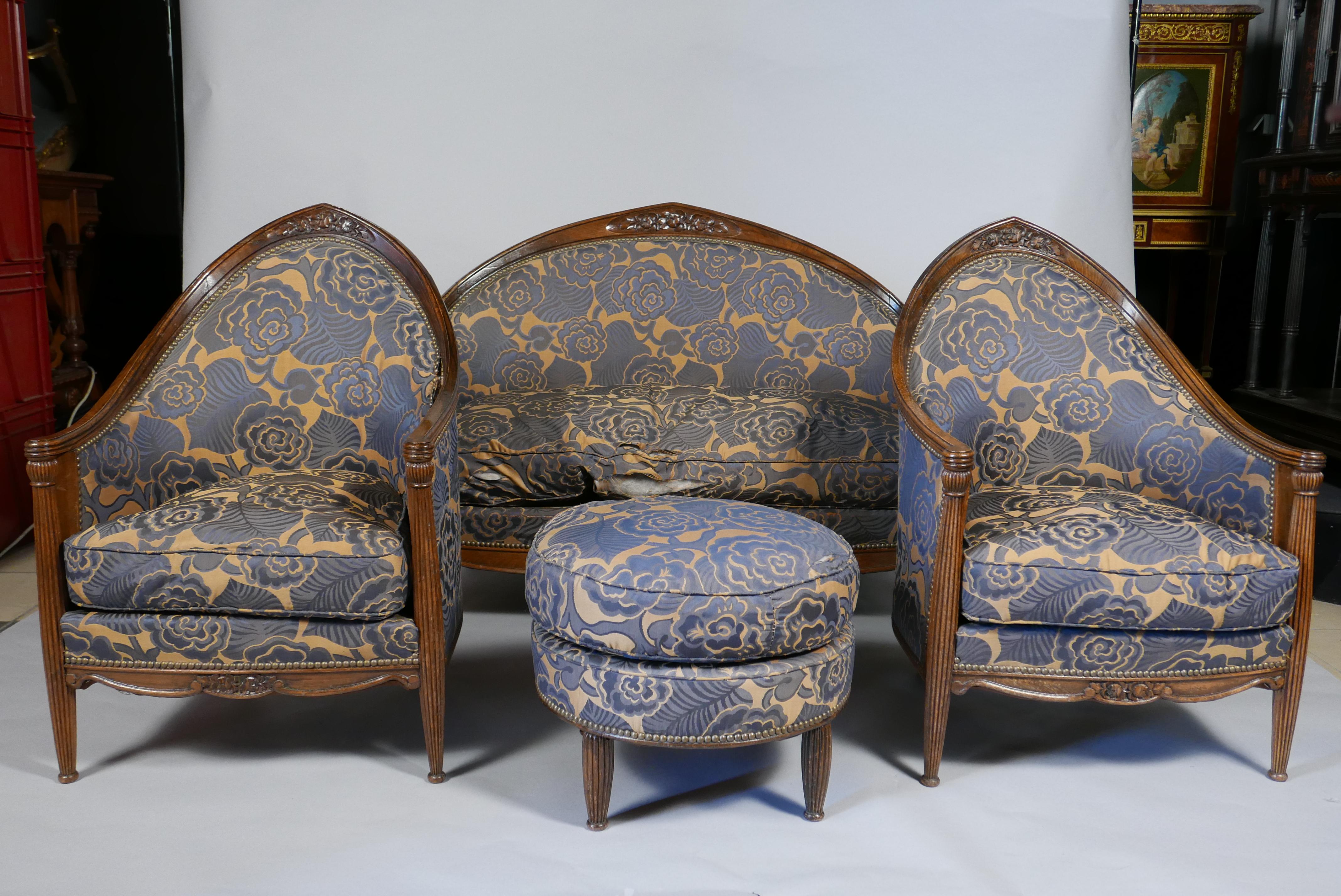 Charming Art Deco salon set including a marquise, a pair of armchairs, a pair of chairs and a stool. They are composed of a gondola-shaped backrest carved with flowers extending to form the armrests with windings for the armchairs and the marquise,