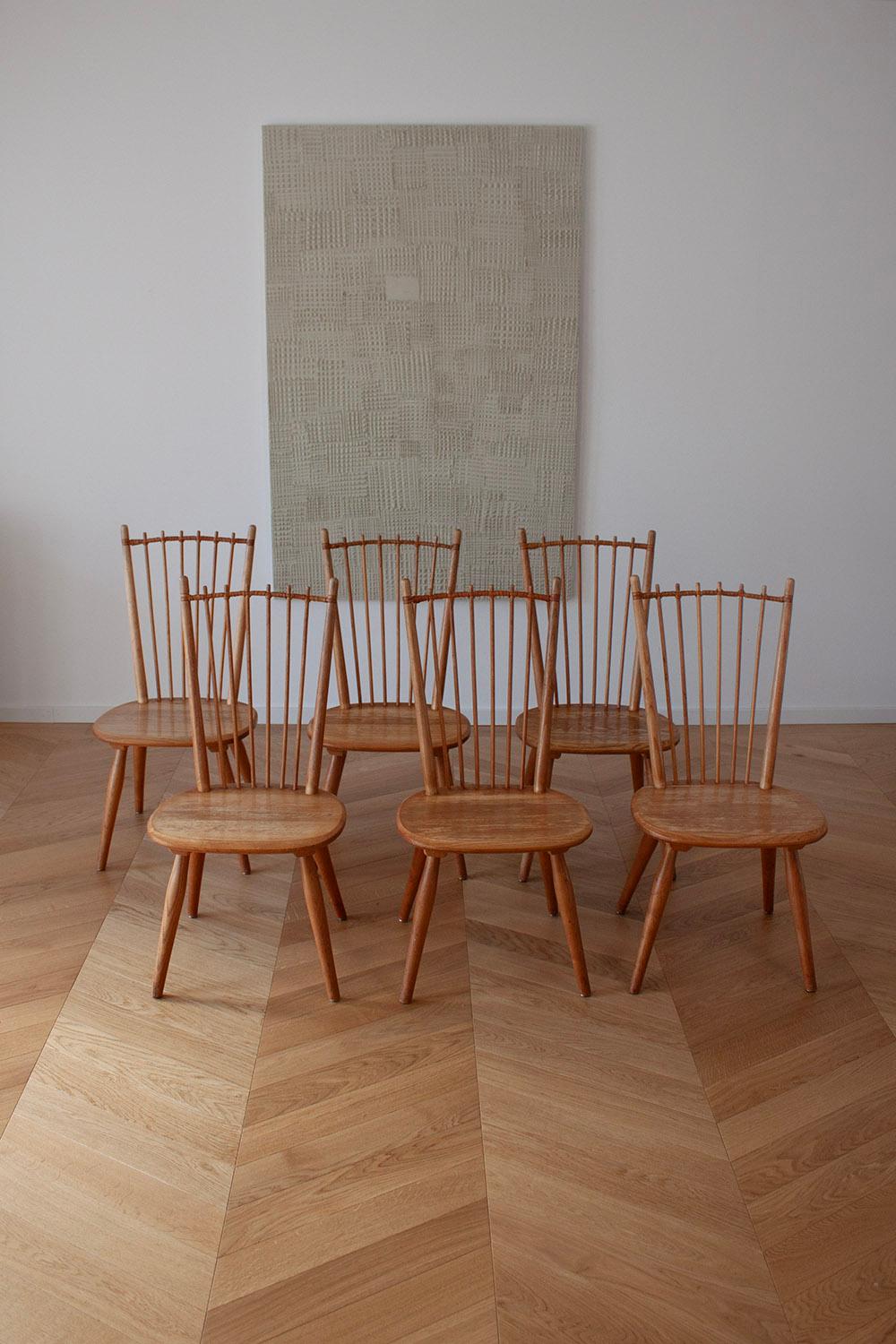 This rare set of 6 dining chairs are designed by Albert Haberer and manufactured by Hermann Fleiner, Germany in ca 1950. These chairs are beautifully crafted with attention to detail. The backrest spindles are skillfully connected with a leather