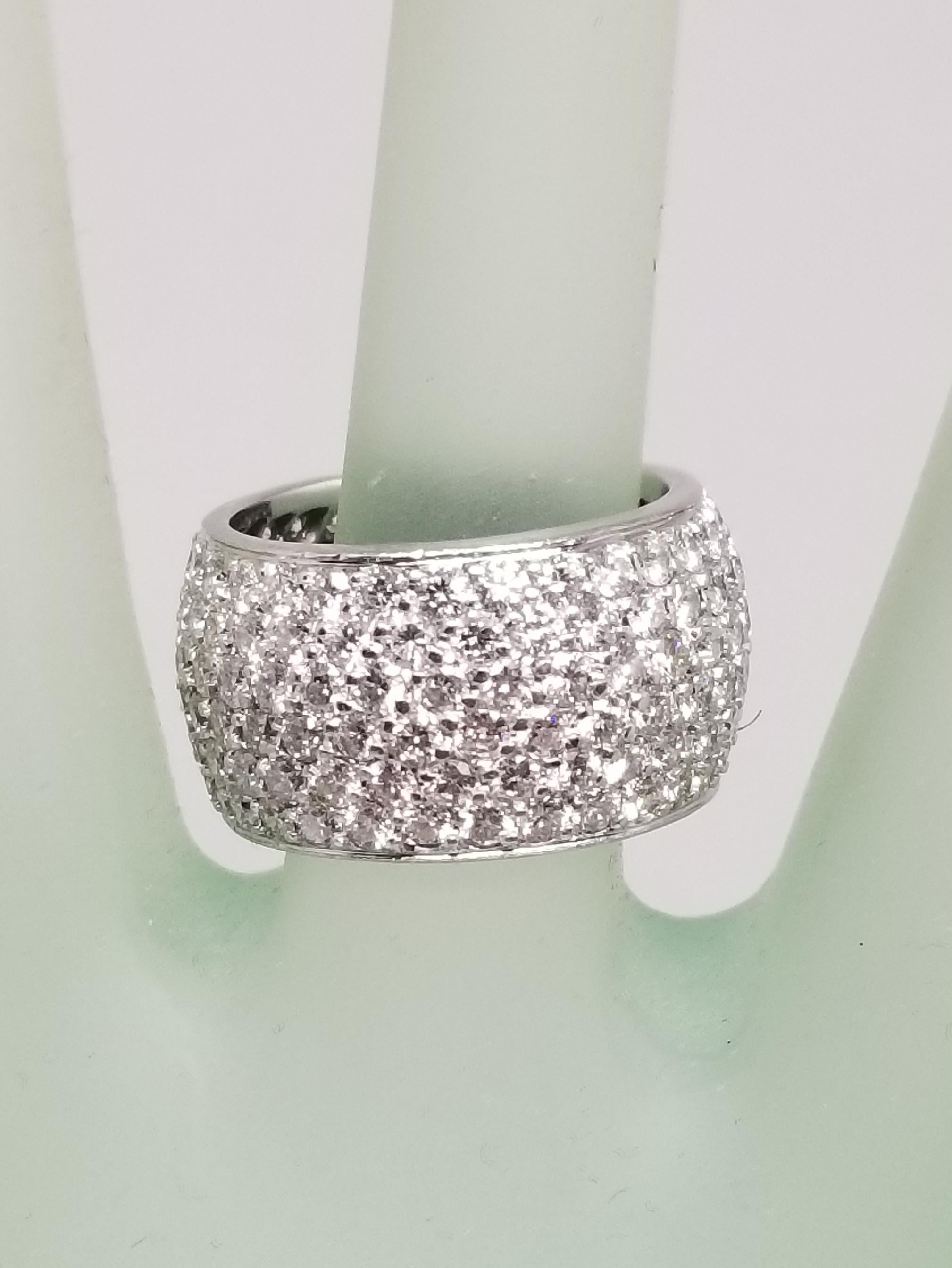 14k white gold 6 row pave' set diamond eternity ring containing 174 round full cut diamonds of very fine quality weighing 7.03cts, ring size is a 6.5 but can be made to fit.