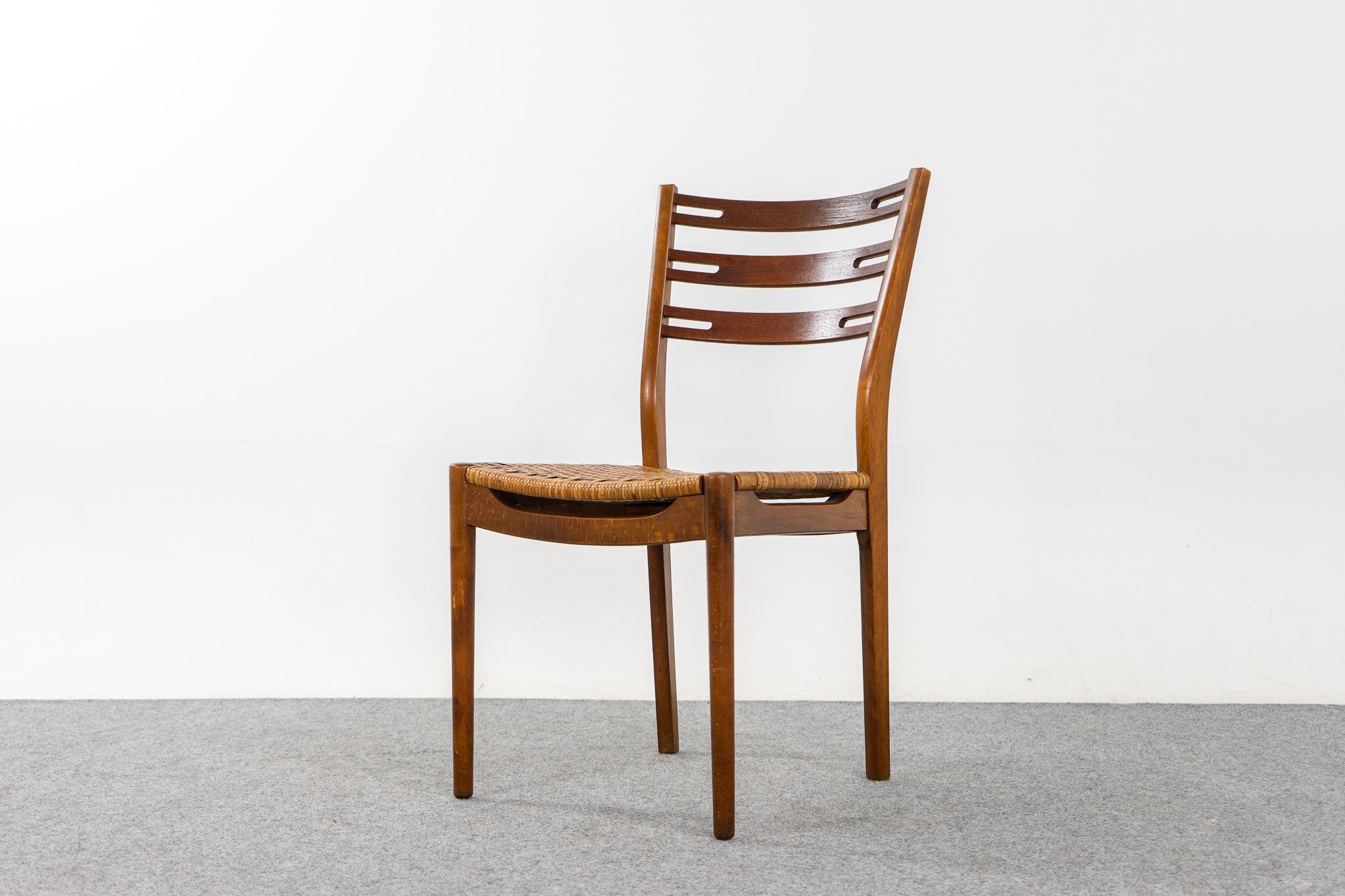 Teak and rattan Della dining chairs by IKEA, circa 1960's. Beautifully curved backrests and generous seat design provide support and comfort. Solid beech frame features slatted teak back. Original rattan seats in good condition.

Unrestored item,